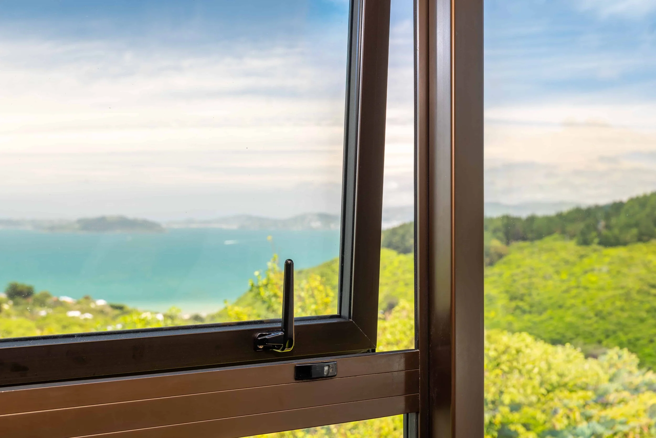 Close up internal view of a bronze aluminium window that has been double glazed by Eversure. reFIT Ali service