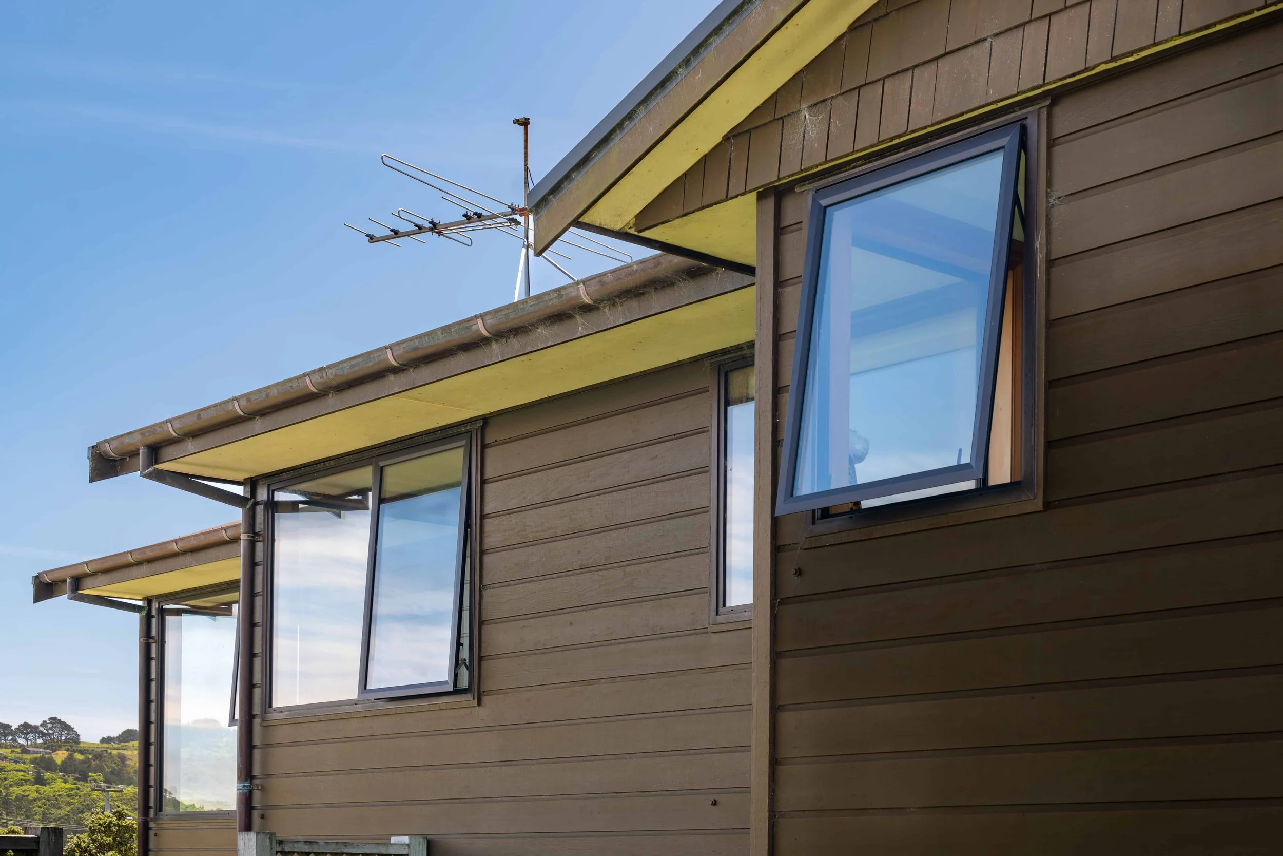 External view showing multiple aluminium windows that were double glazed by Eversure. reFIT Ali service