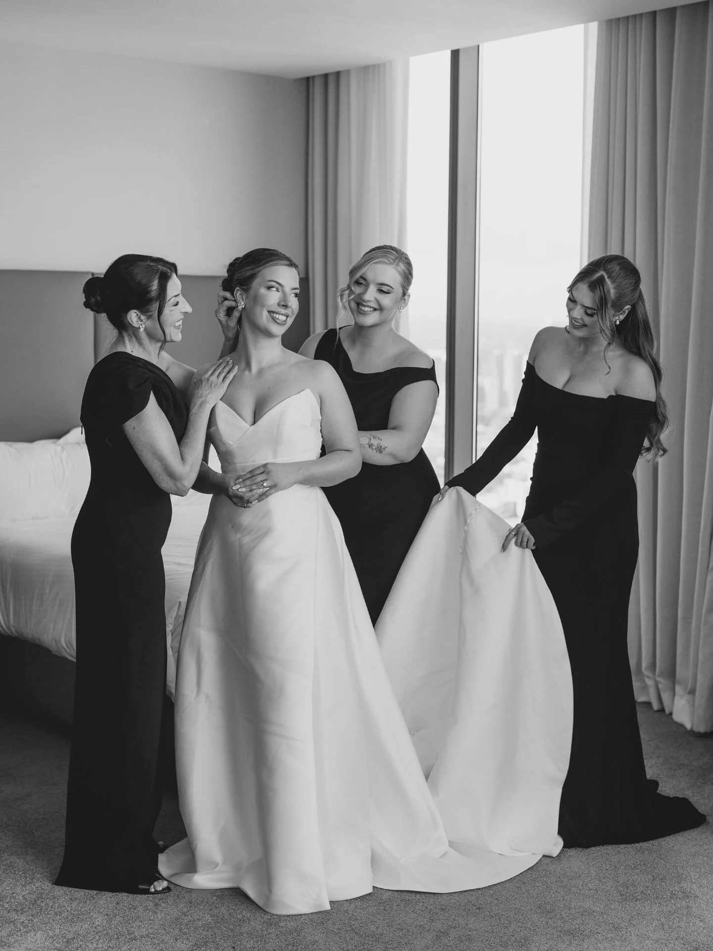 A quiet, meaningful moment before the day unfolds.
Montana surrounded by her closest Women — her beautiful Mum, Sister and Best Friend — helping her into her @madewithlovebridal wedding dress and sharing the emotion of watching their Dau