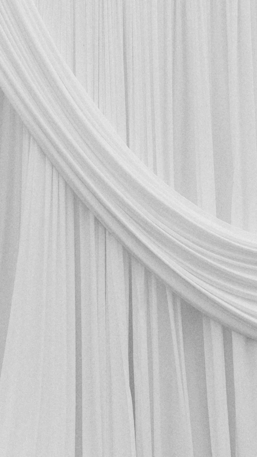 Close-up of a sheer white curtain with a draped swath.