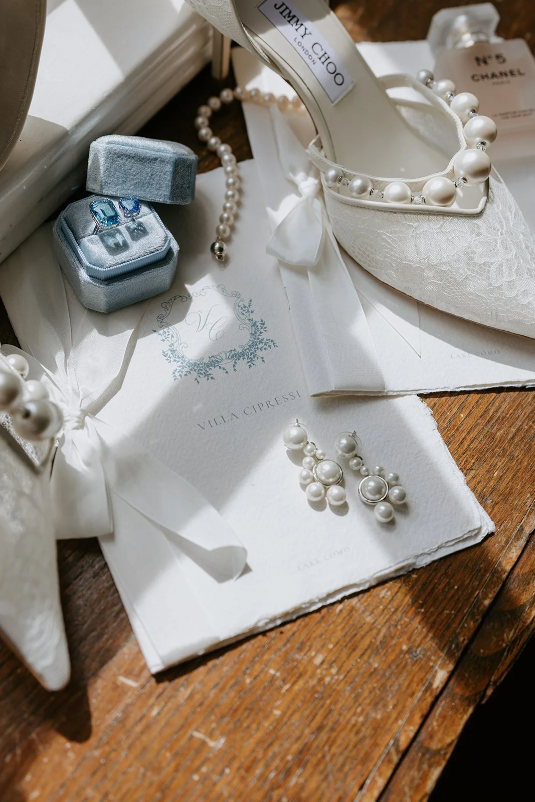 Luxury wedding at Villa Cipressi at Lake Como, Italy, featuring perl earrings, wedding stationery and soft ivory styling