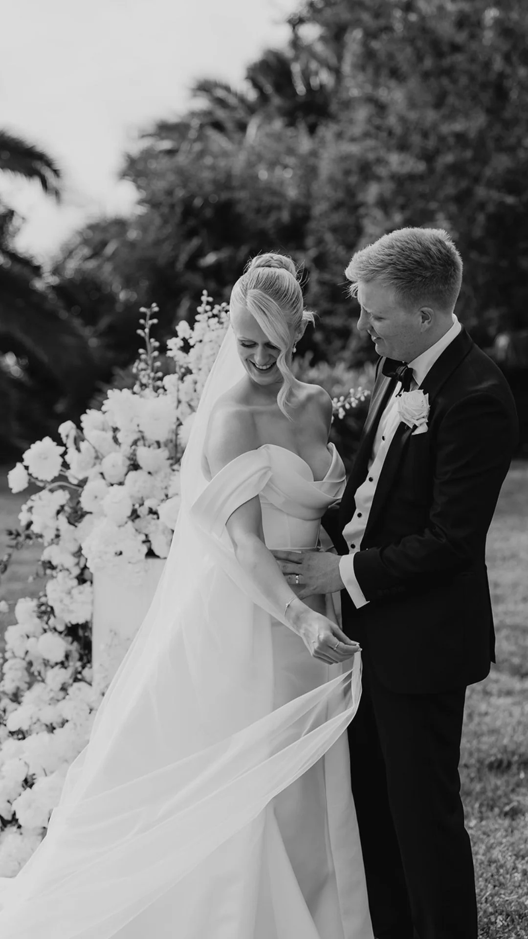 A bride and groom smiling and holding hands during their wedding ceremony at Perricoota Station outdoors with their Melbourne wedding photographer love by shae.