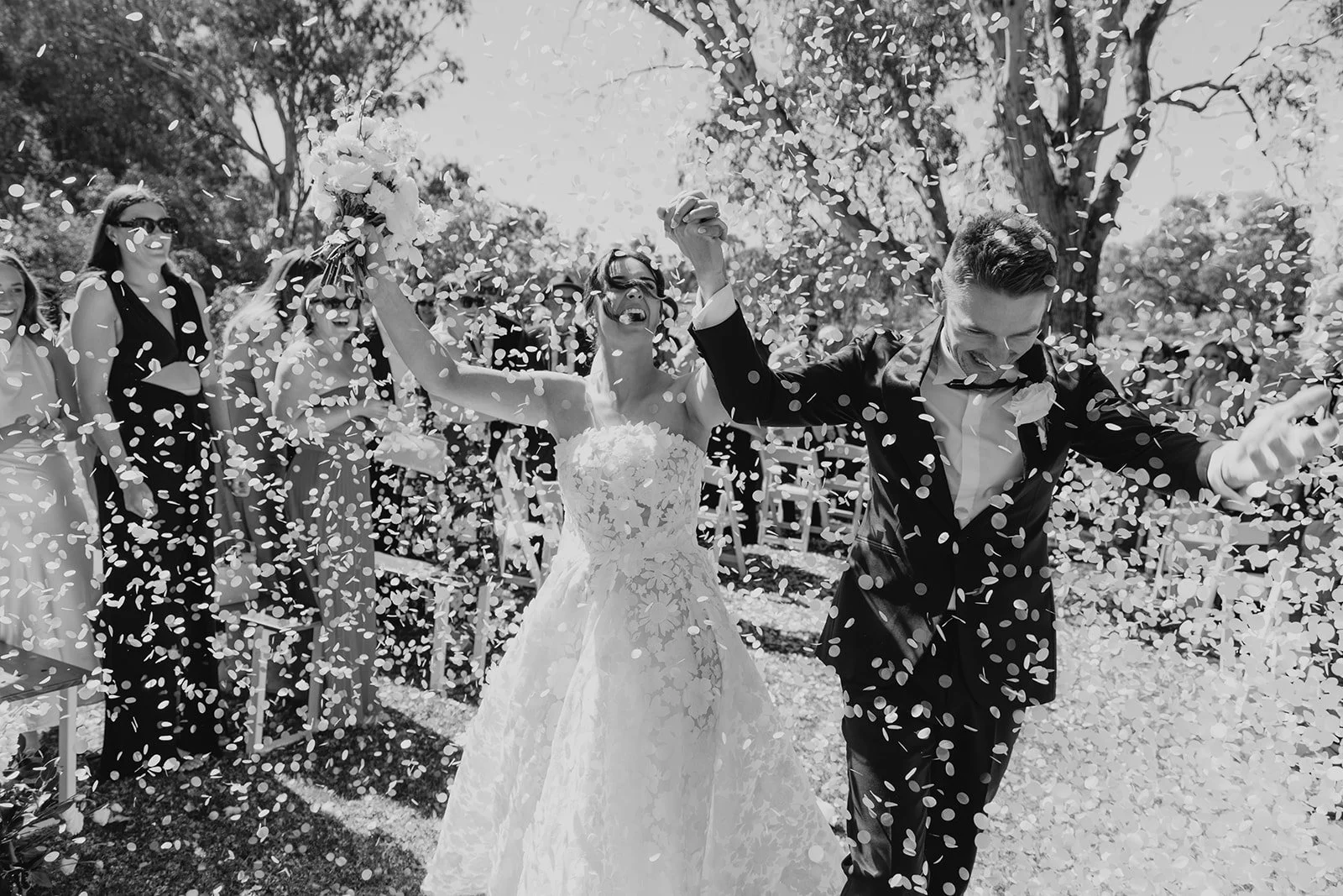 Newlyweds celebrating beneath a shower of confetti