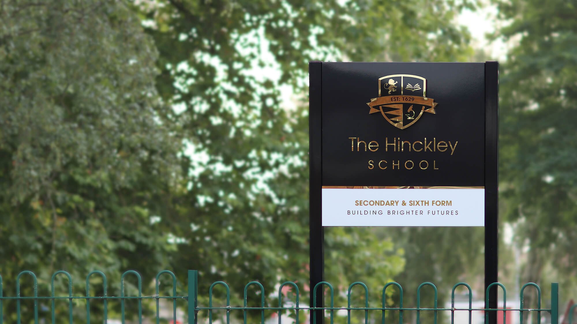 the hinckley school sign black and gold