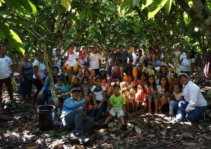  Members of the ACOPAGRO co-op in Peru and their children pose with cacao pods. 