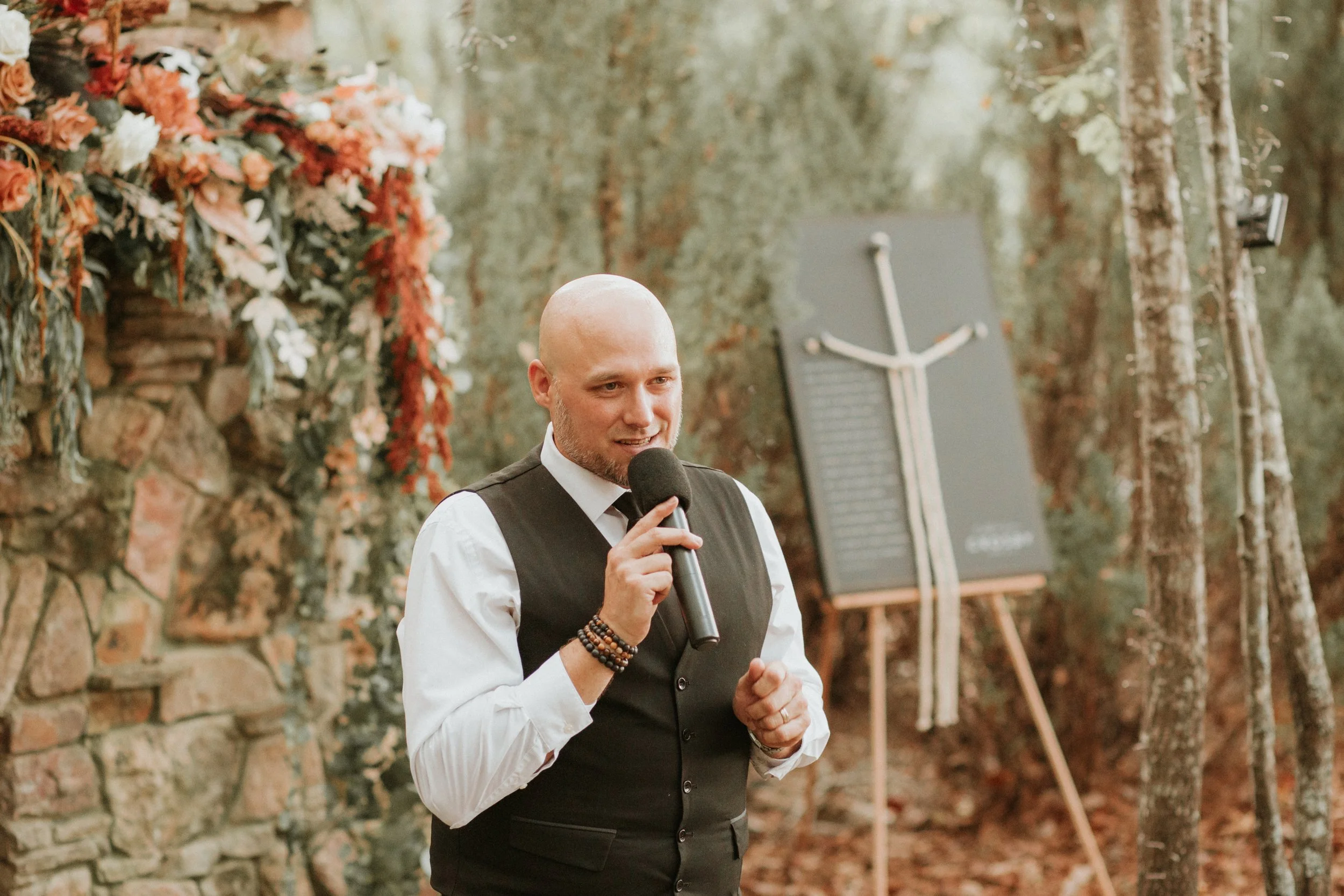 DJ mixing music on a laptop at a crowded indoor event or party.