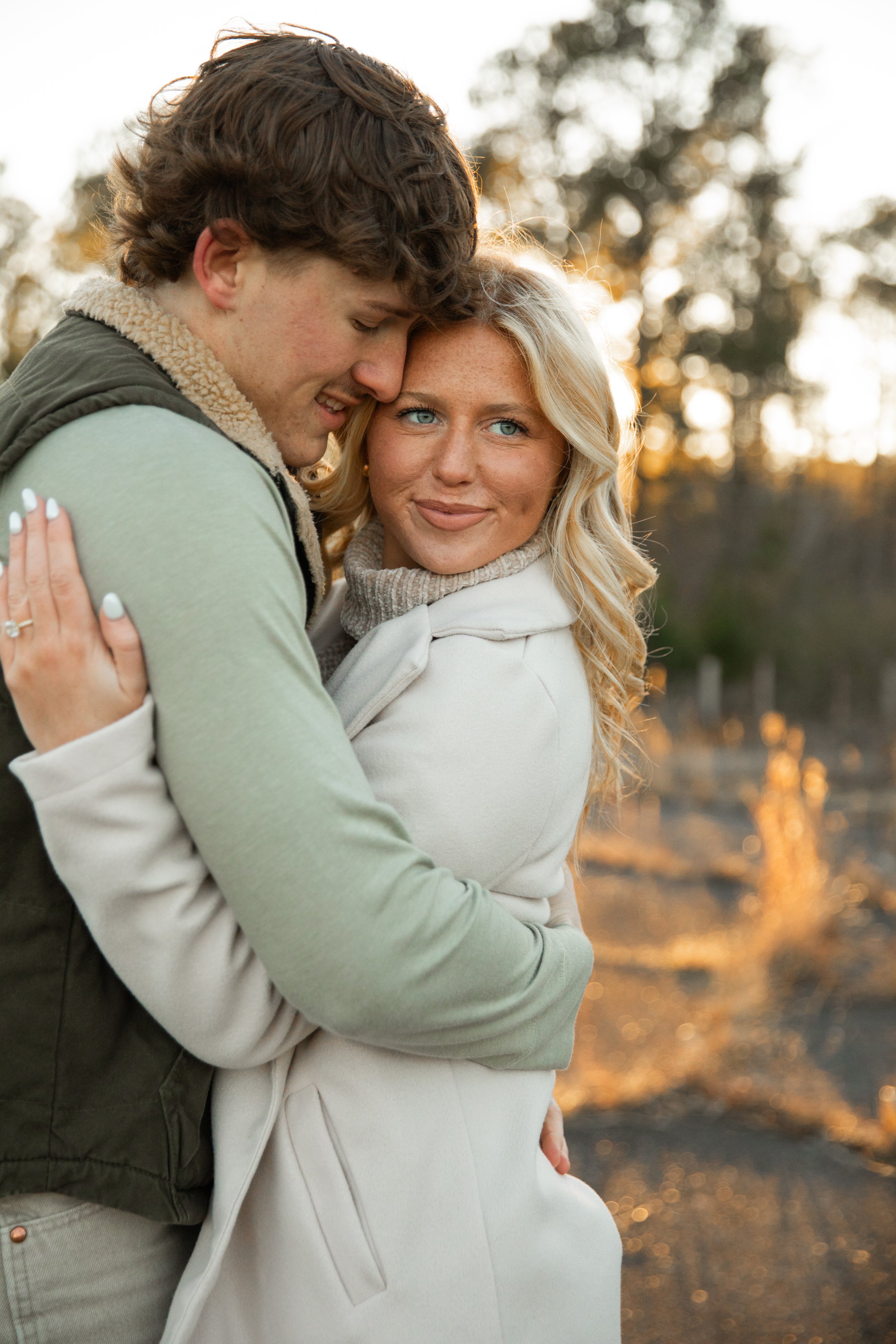 Cozy winter engagement session in a field