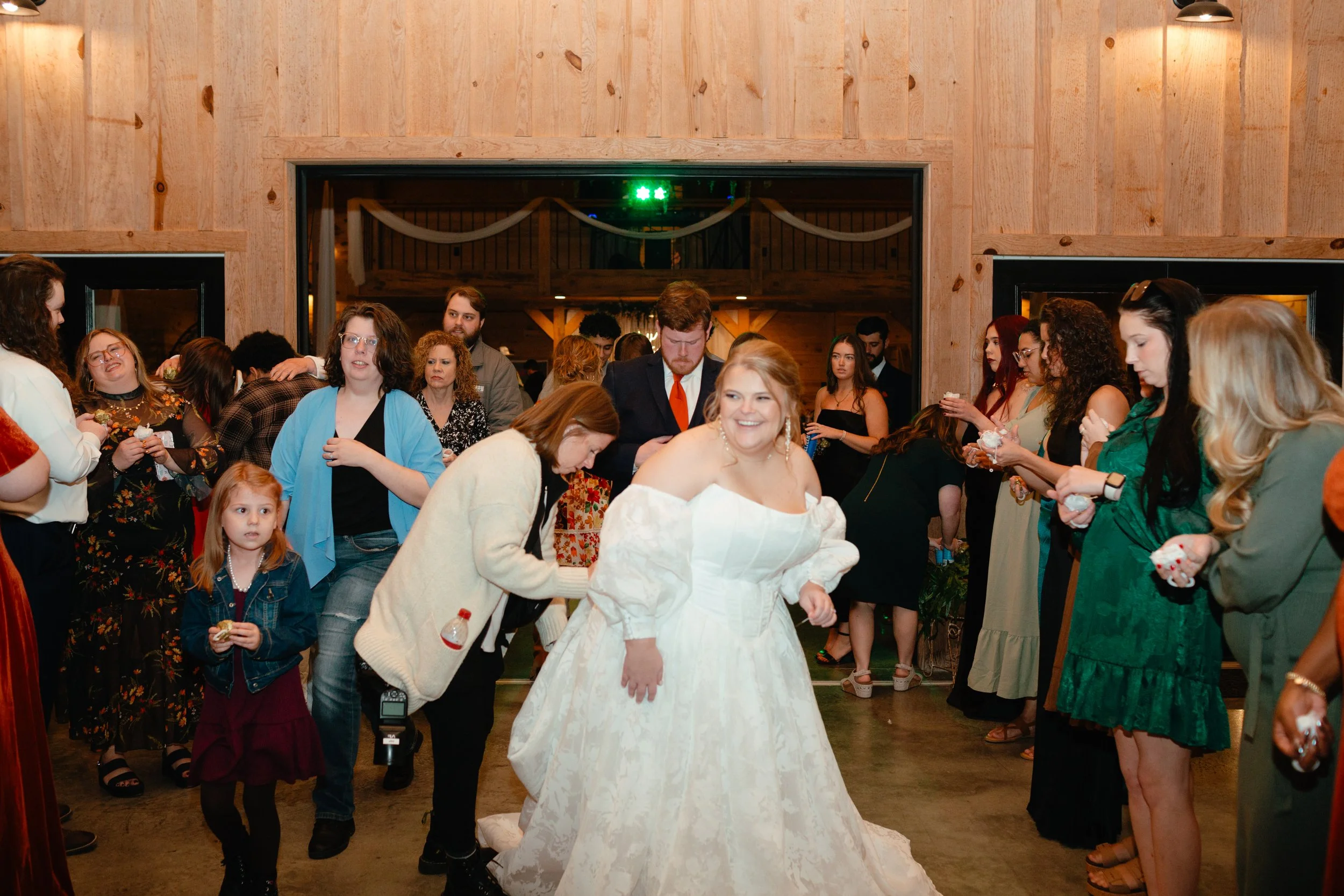 Wedding photography helping bride with her bustle