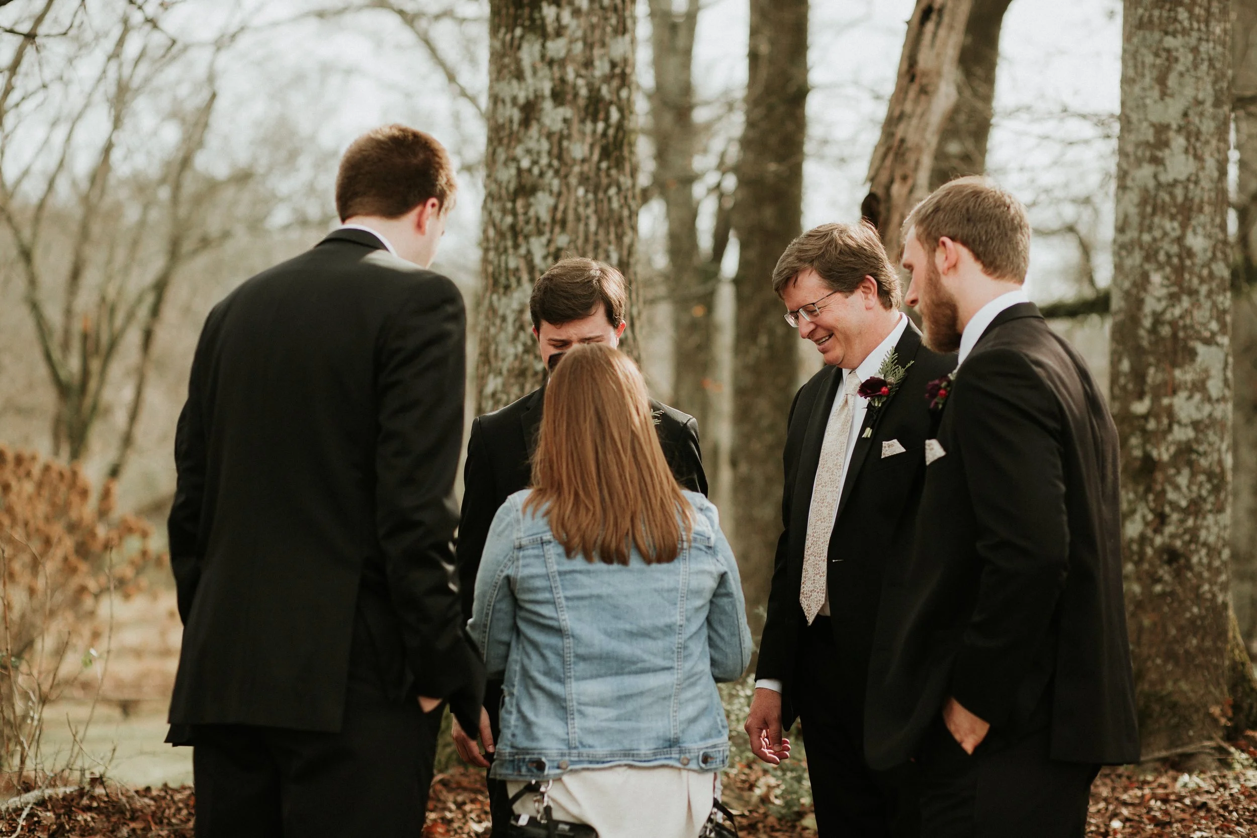 Wedding Photographer helping groomsmen