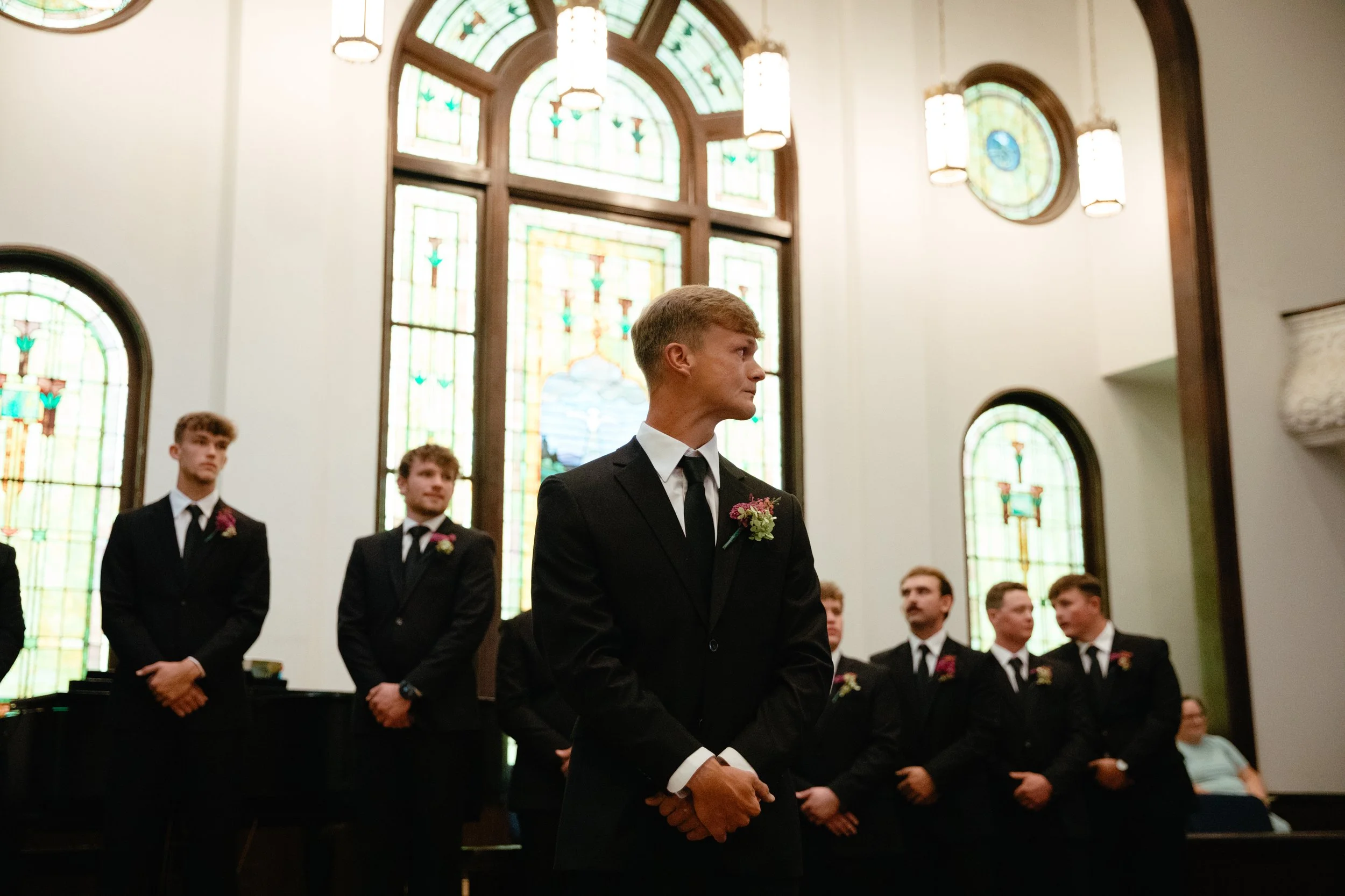 Groom seeing his bride for the first time in a church wedding, crying