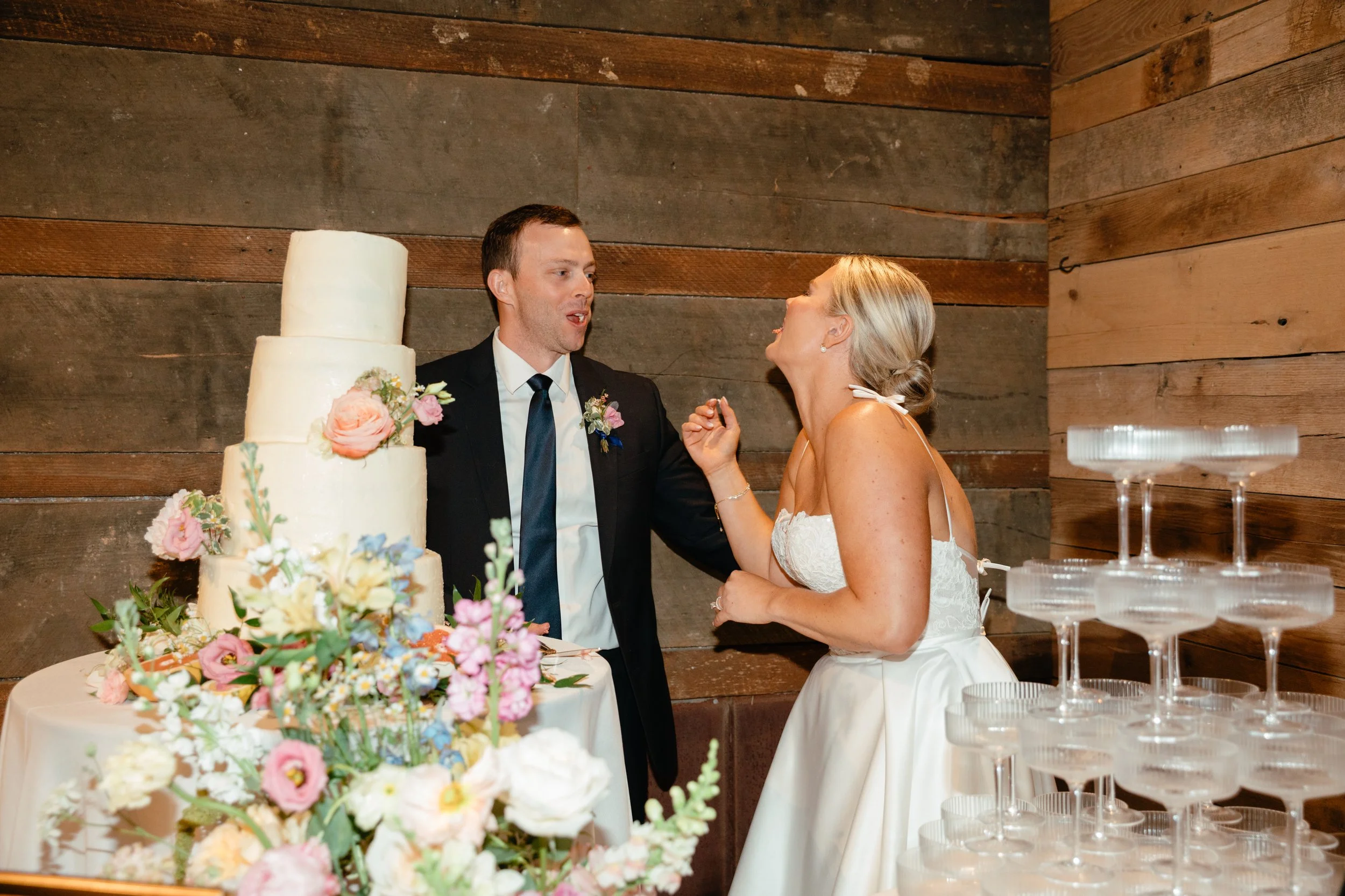 Couple having fun cutting the cake at the Barn at Bennett Flats, Heflin, Alabama