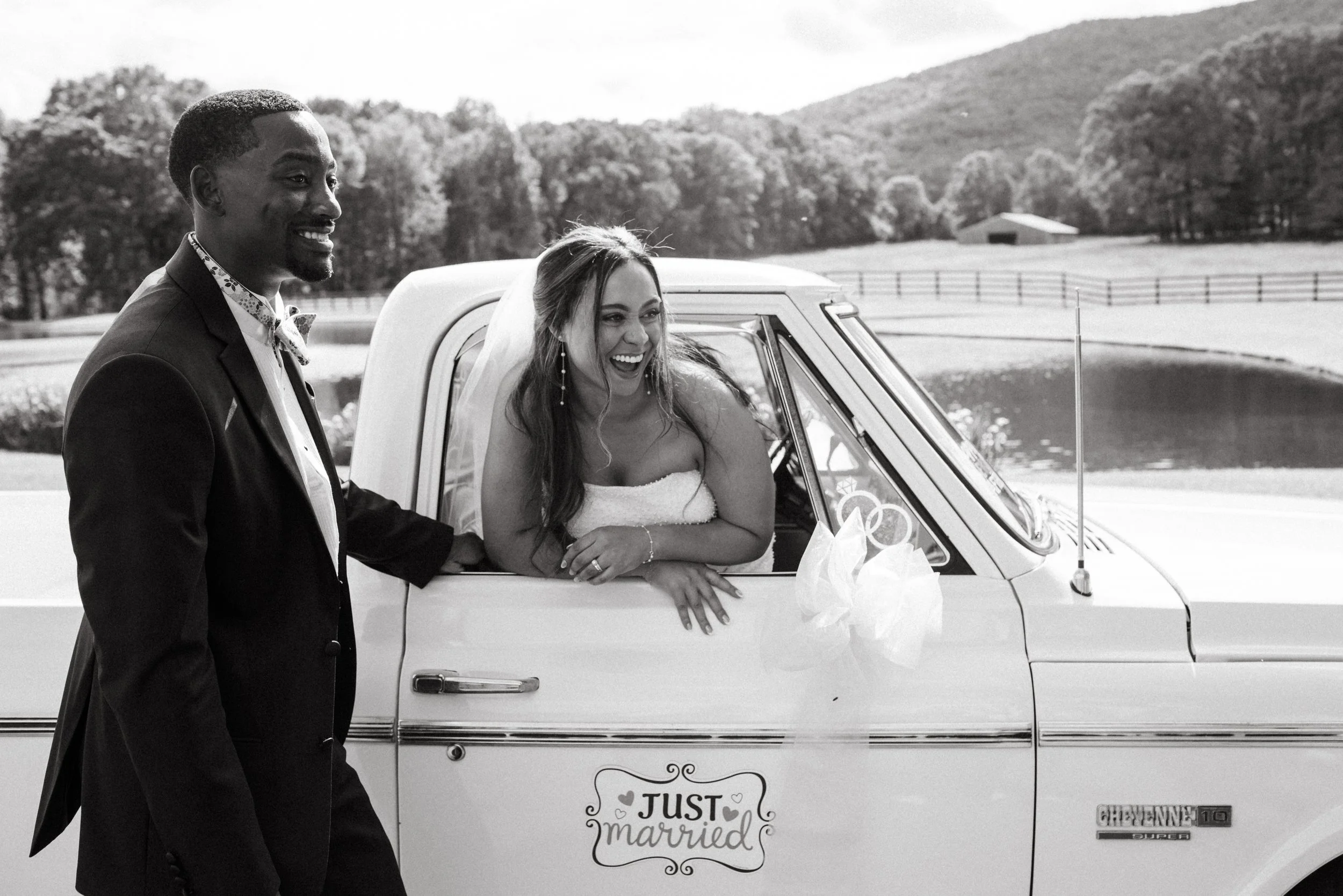 wedding couple laughing in get away car vintage truck