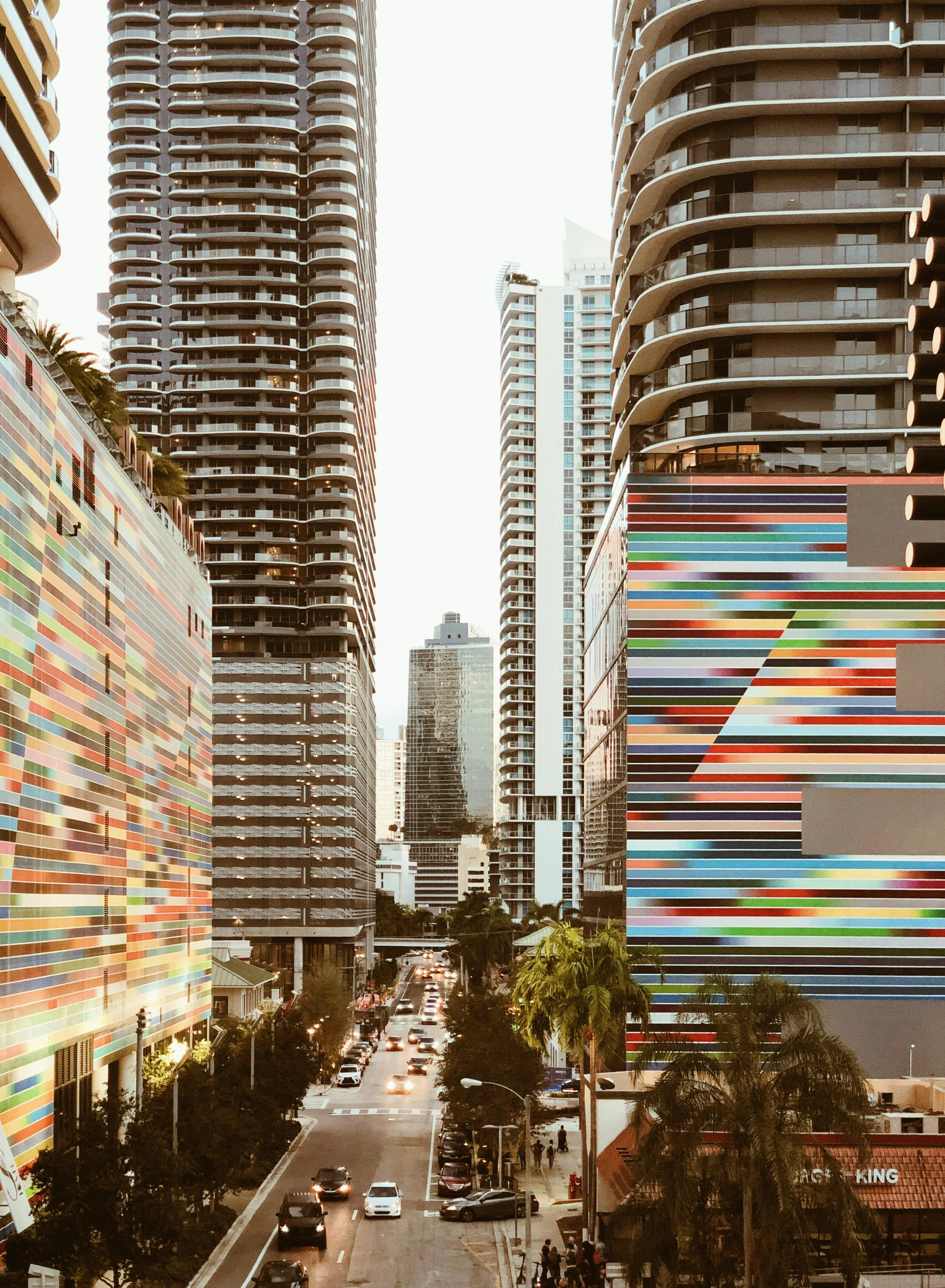 Miami's downtown streets with both cars and sidewalks for walking, surrounded by tall buildings on either side.