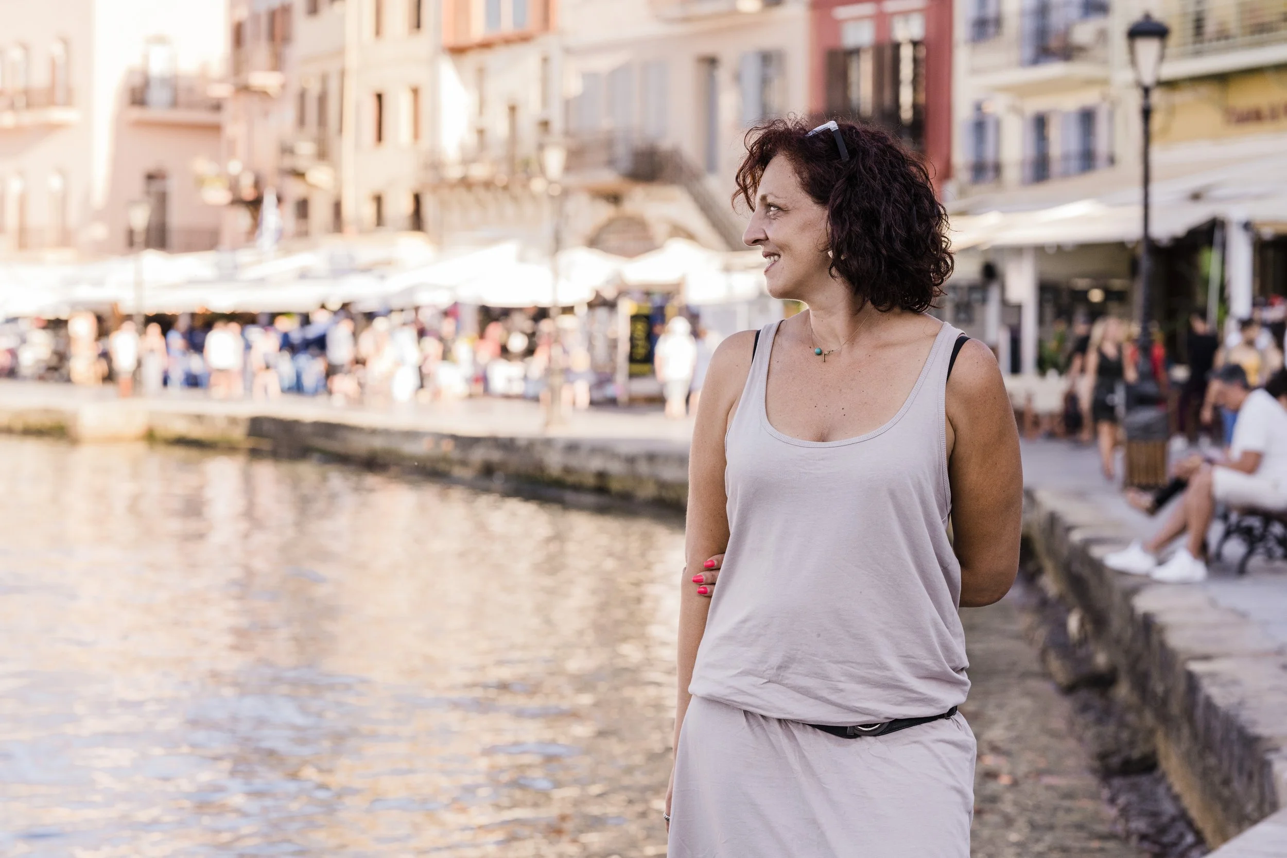 Gabi, Ella Travel advisor for the Greek Islands, standing on the waterfront in Chania, Crete.