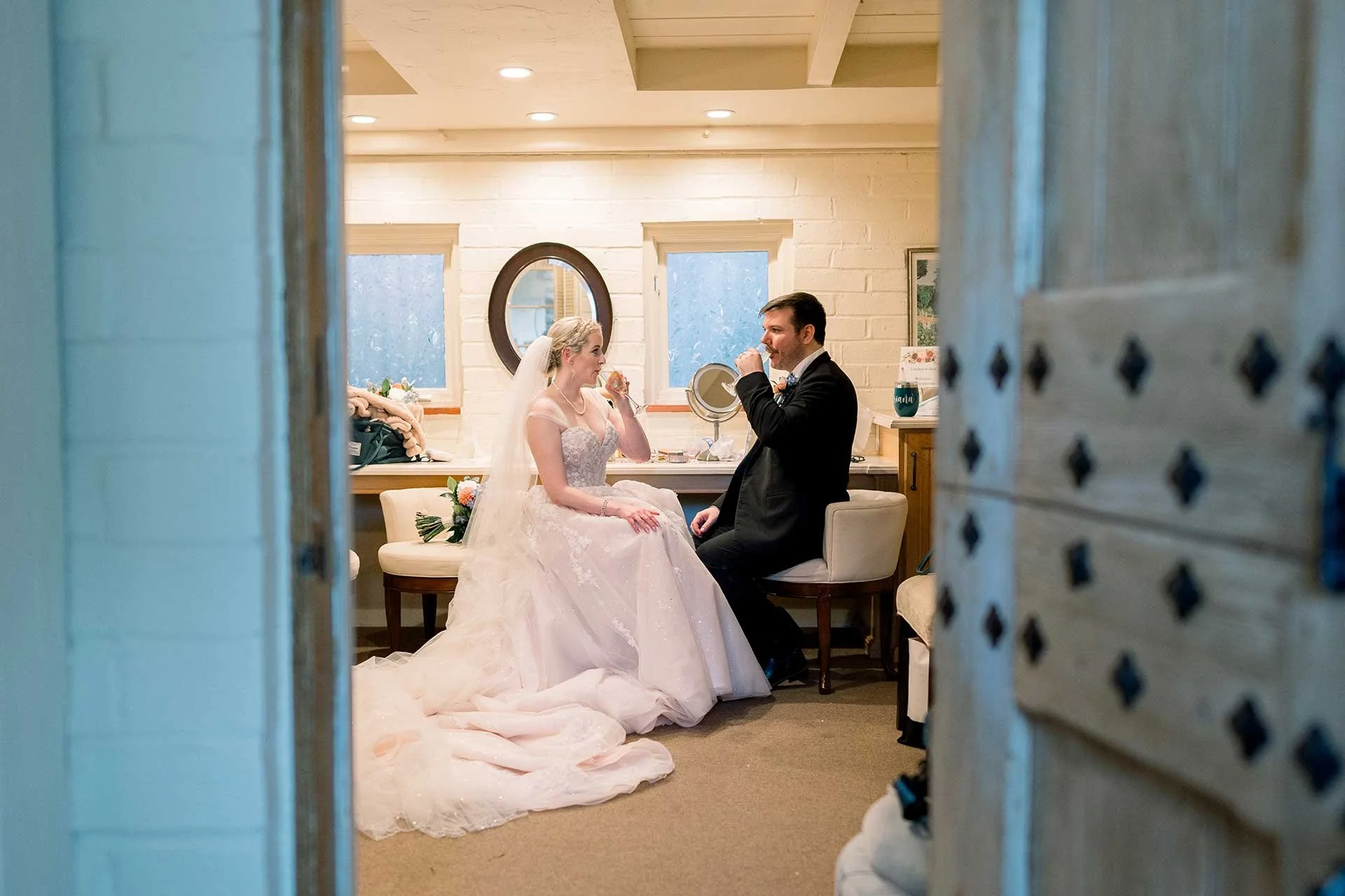 luxury wedding planning couple taking a minute to drink champagne together after their wedding ceremony