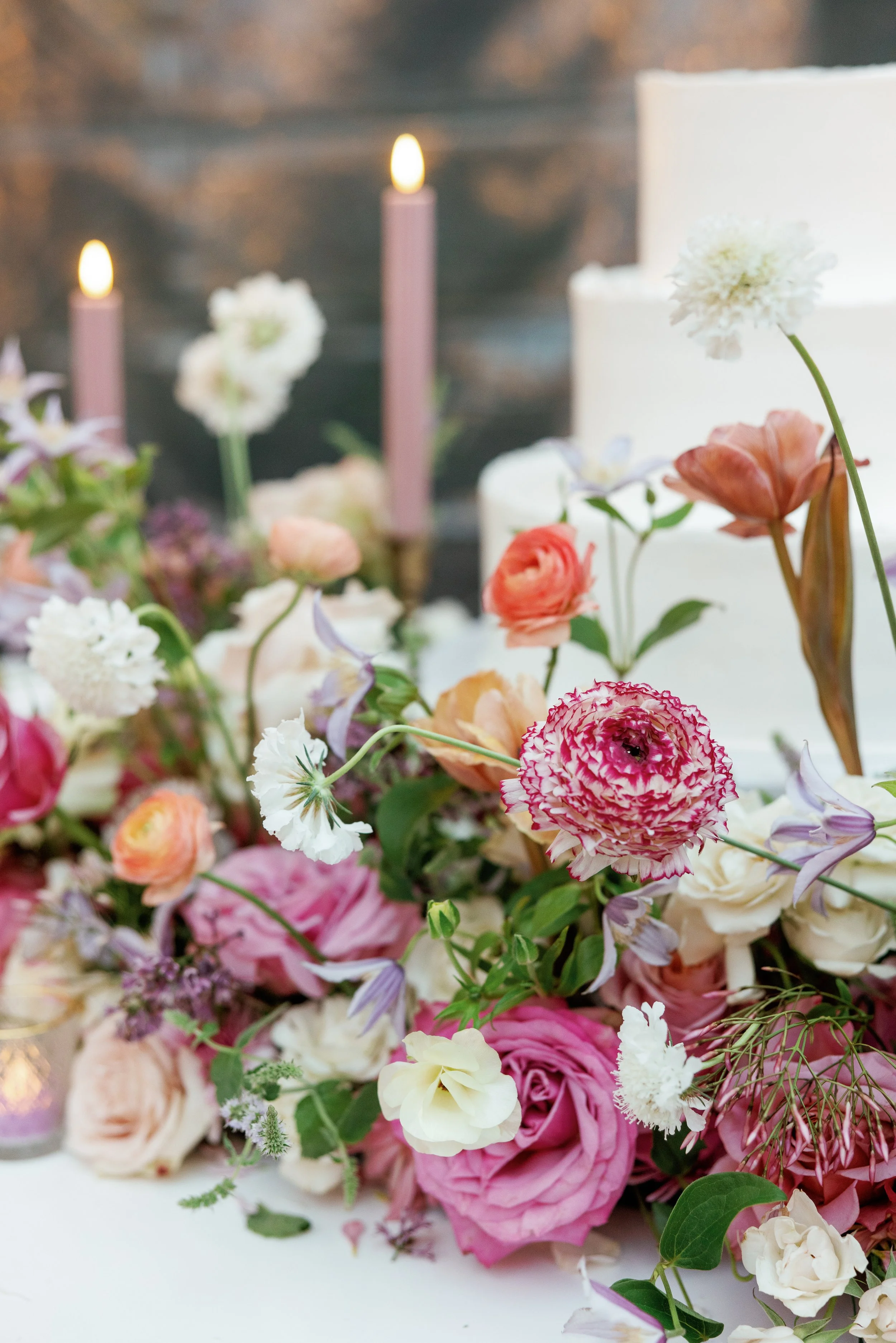 Textured summer wedding florals with soft color palette creating intentional and elevated reception design