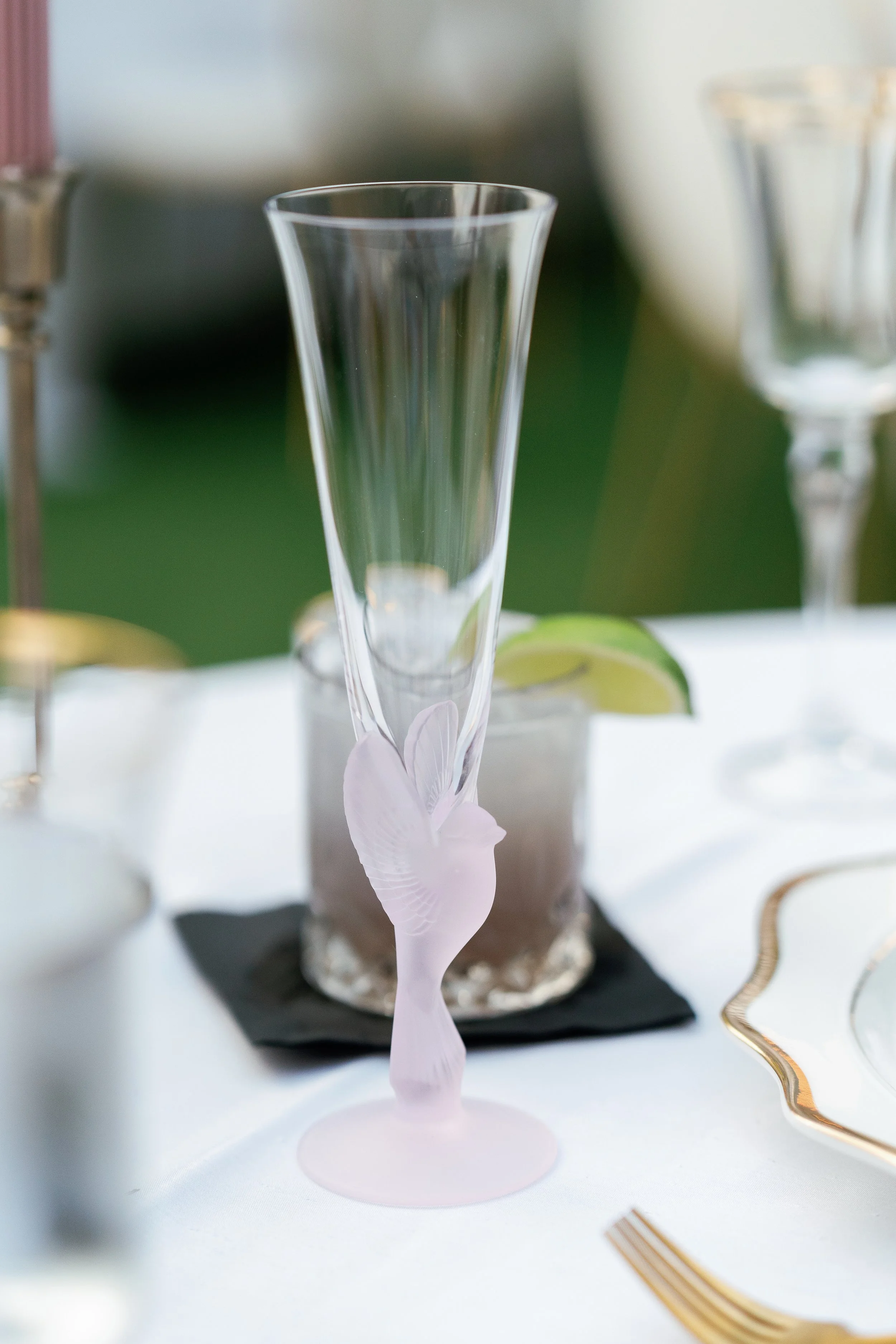 Table setting styled with glassware and linens for high-end wedding reception