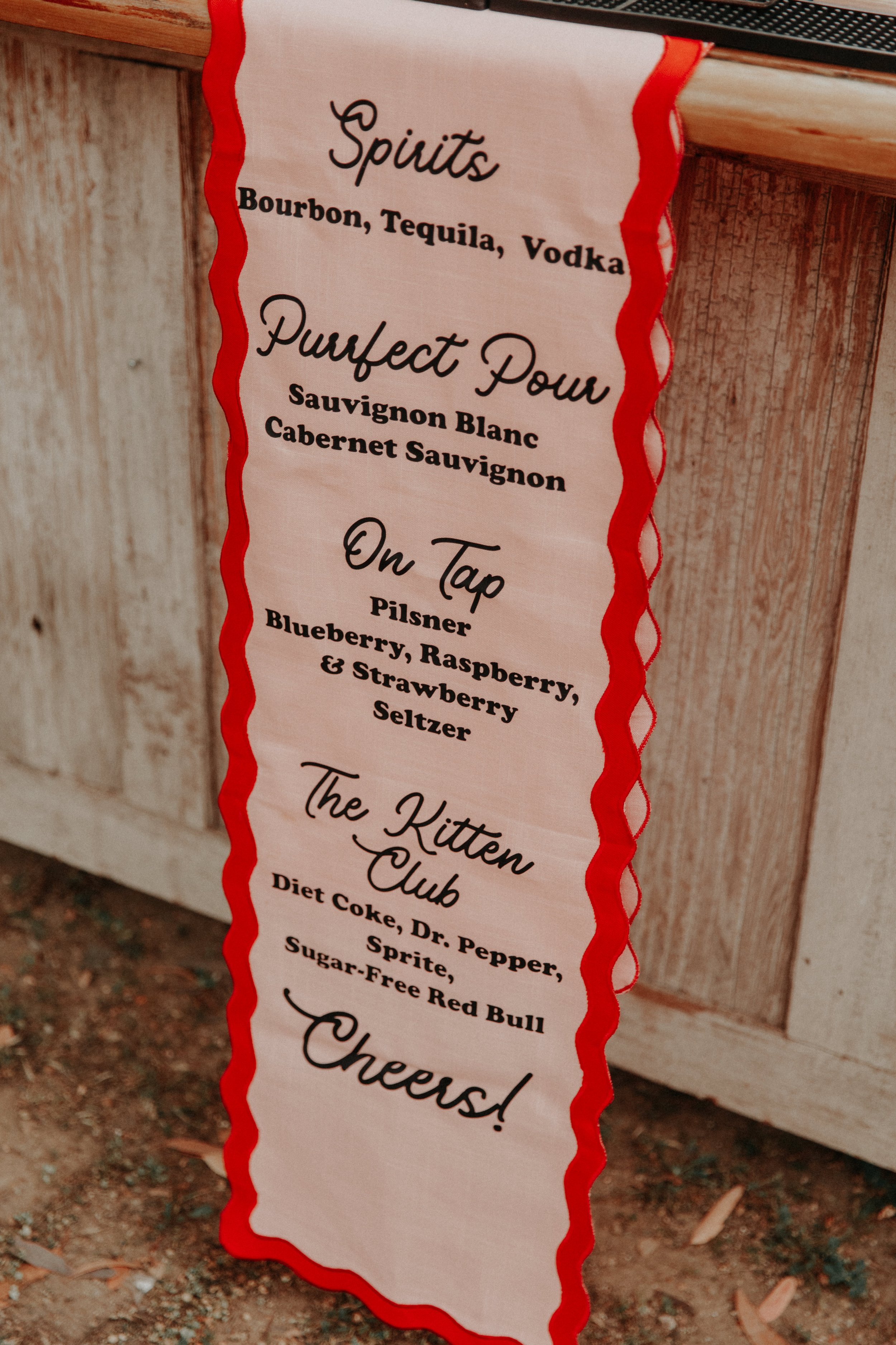Custom wedding bar menu sign with playful cocktail names and retro-inspired colorful design details