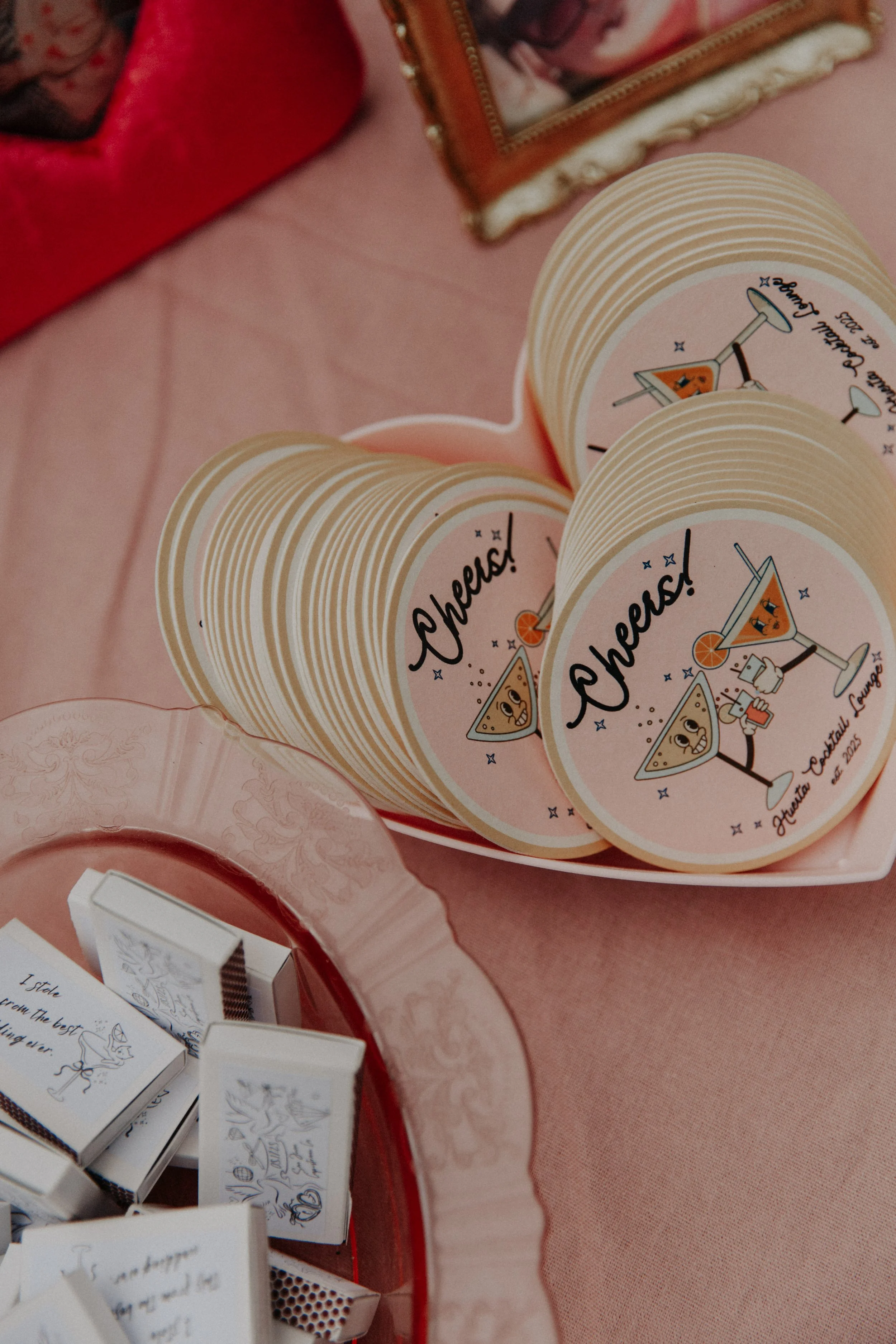 Retro-inspired wedding coasters displayed in heart-shaped dish at playful kitschy wedding reception