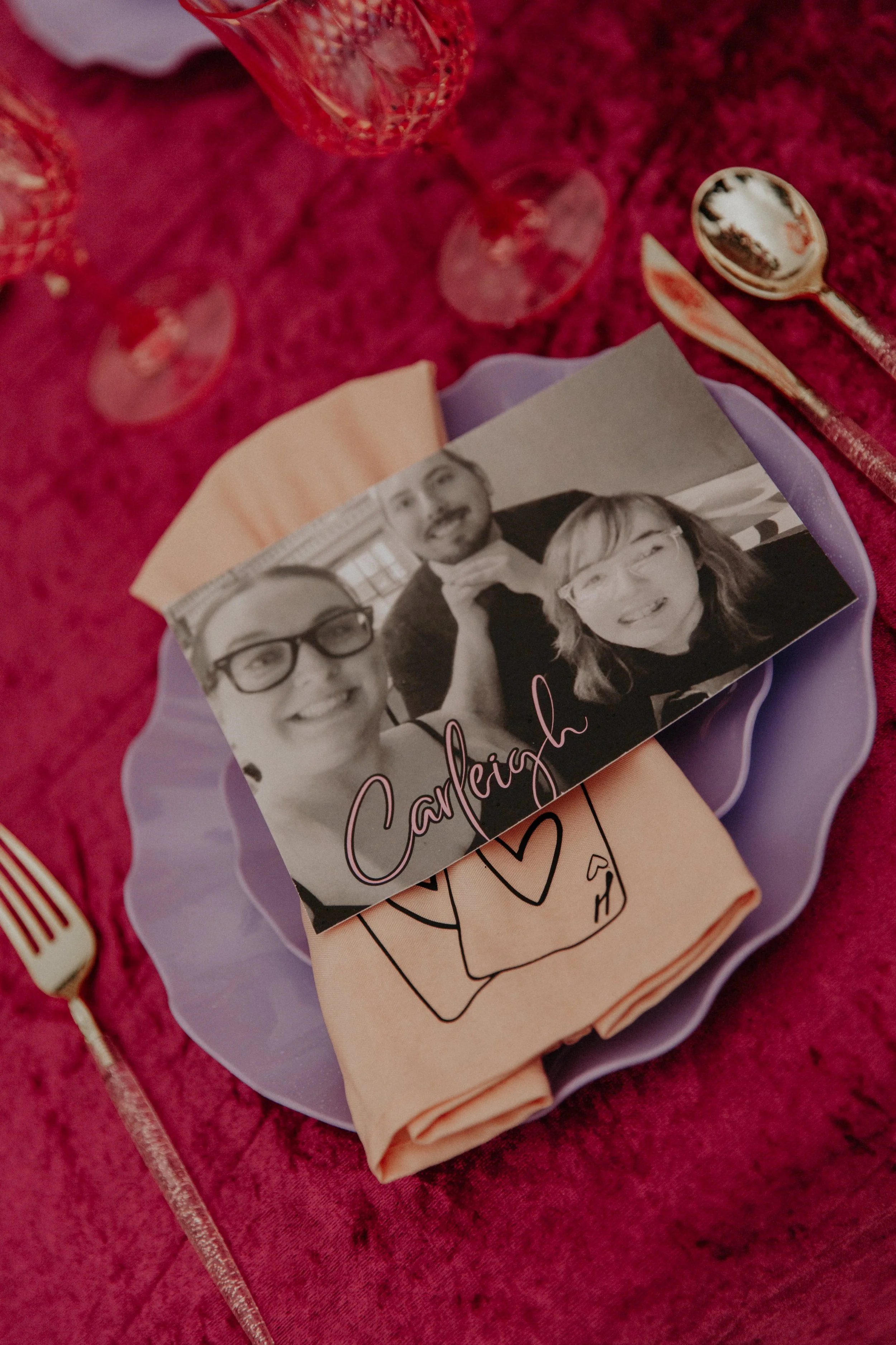 Personalized alternative wedding place setting with custom guest photo card, colorful linens, and playful romantic details