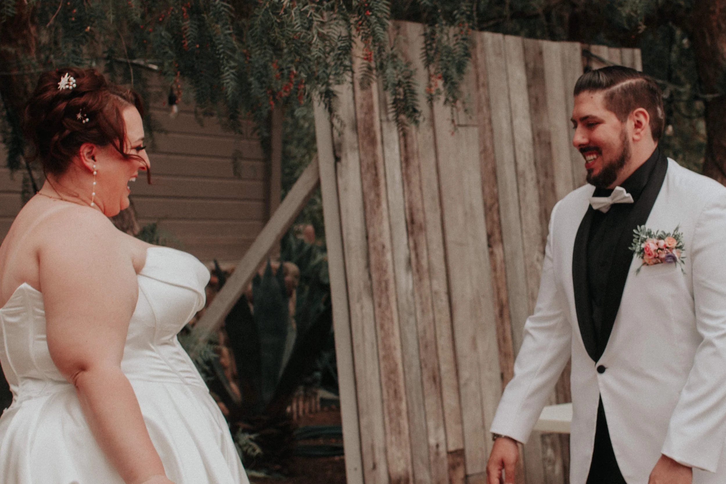 Newlywed couple joyful arch at colorful alternative wedding reception