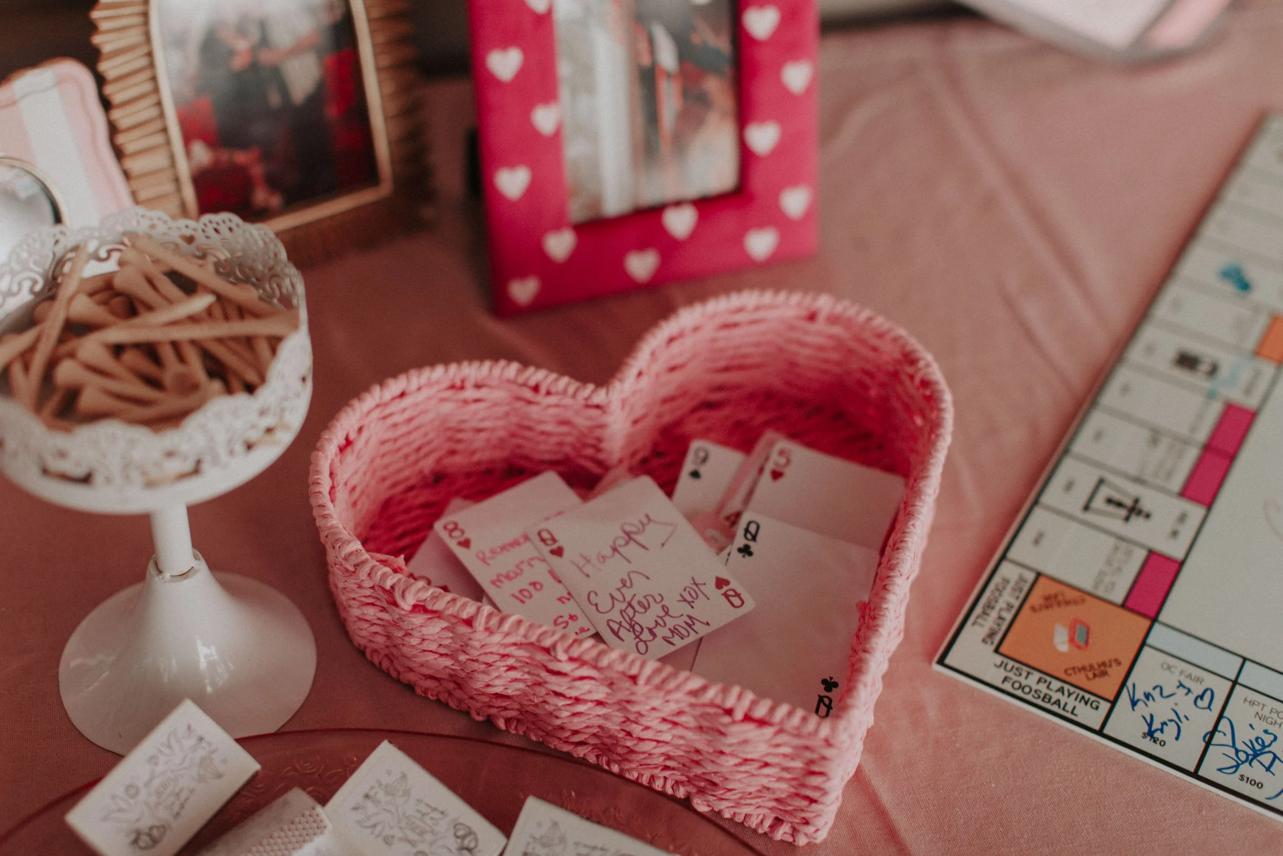 Interactive wedding reception game table with cards, Monopoly board, and playful date night prompts
