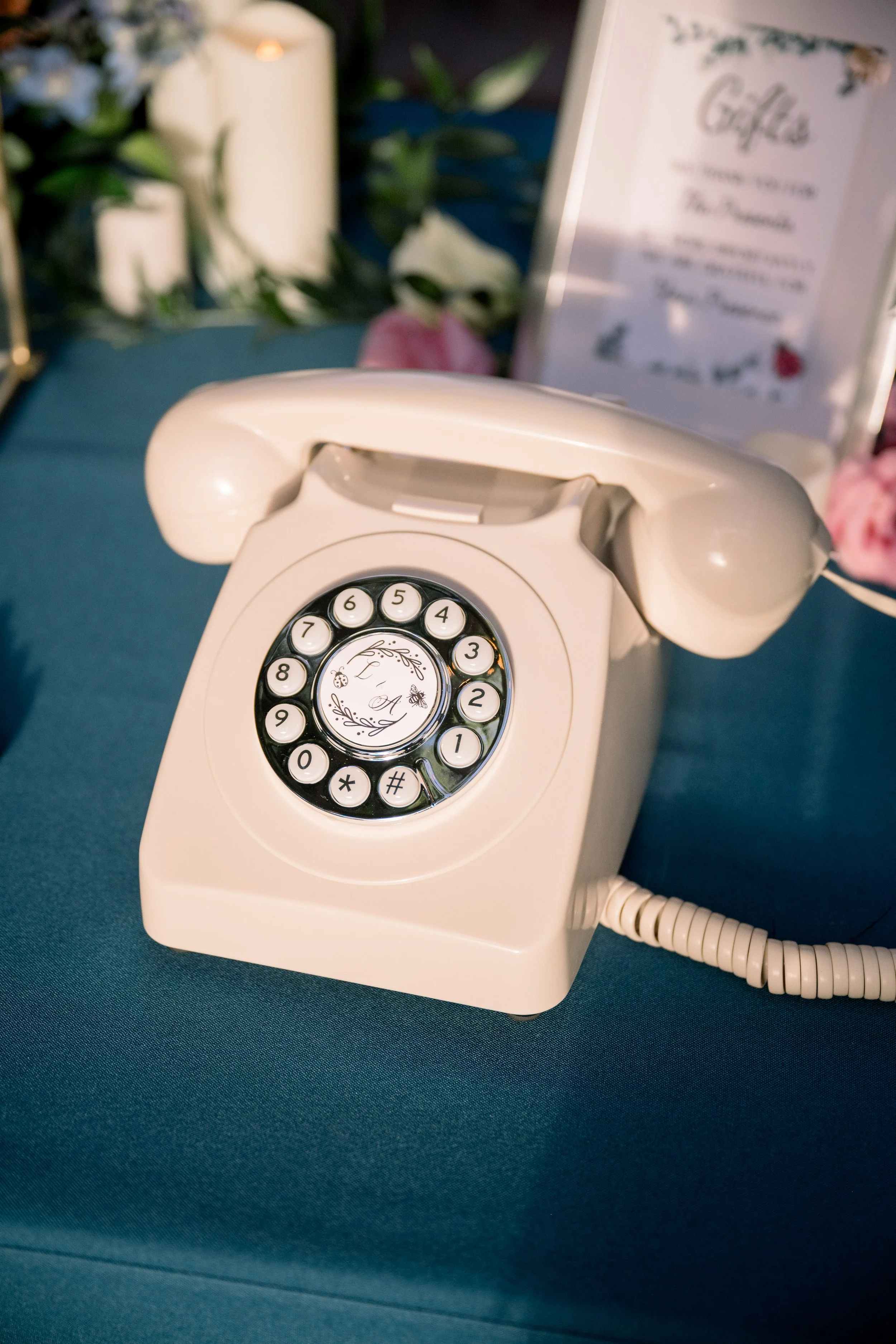 Vintage-style telephone used as an audio guestbook displayed on a wedding reception table