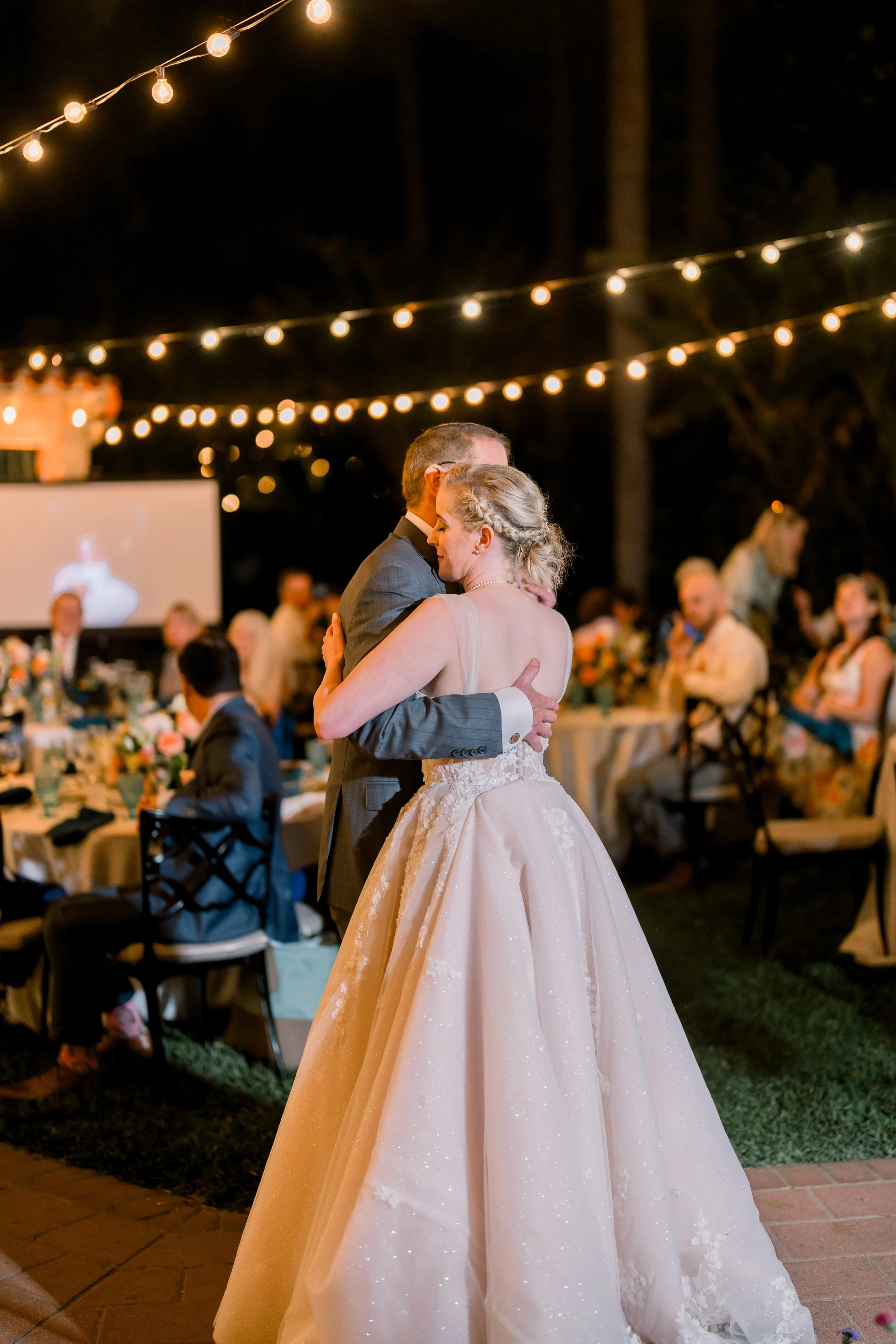 Father Daughter Dance Under String Lights at Outdoor Wedding Reception