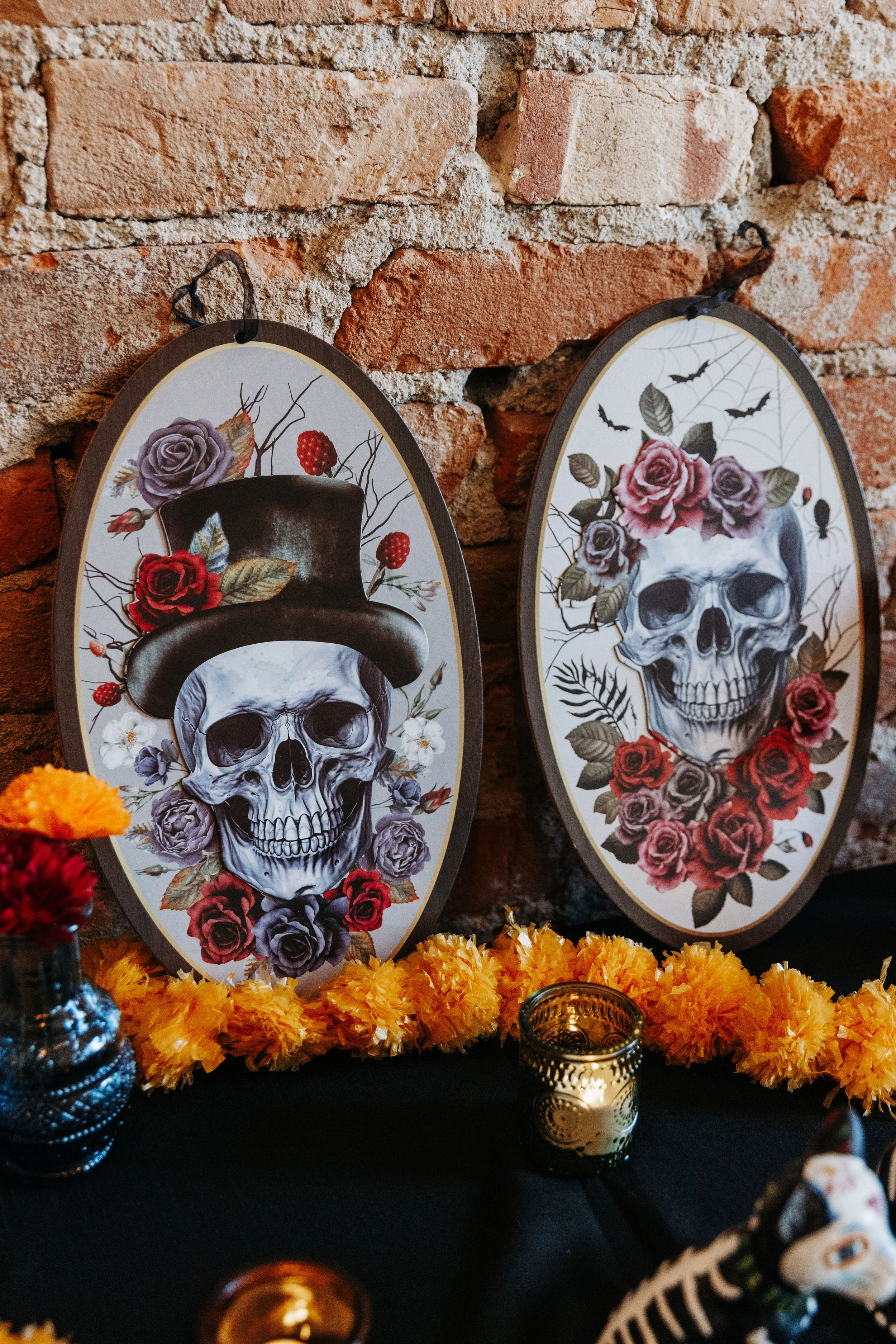 Decor display featuring skull artwork, colorful florals, and Día de los Muertos-inspired details used throughout the wedding reception design.