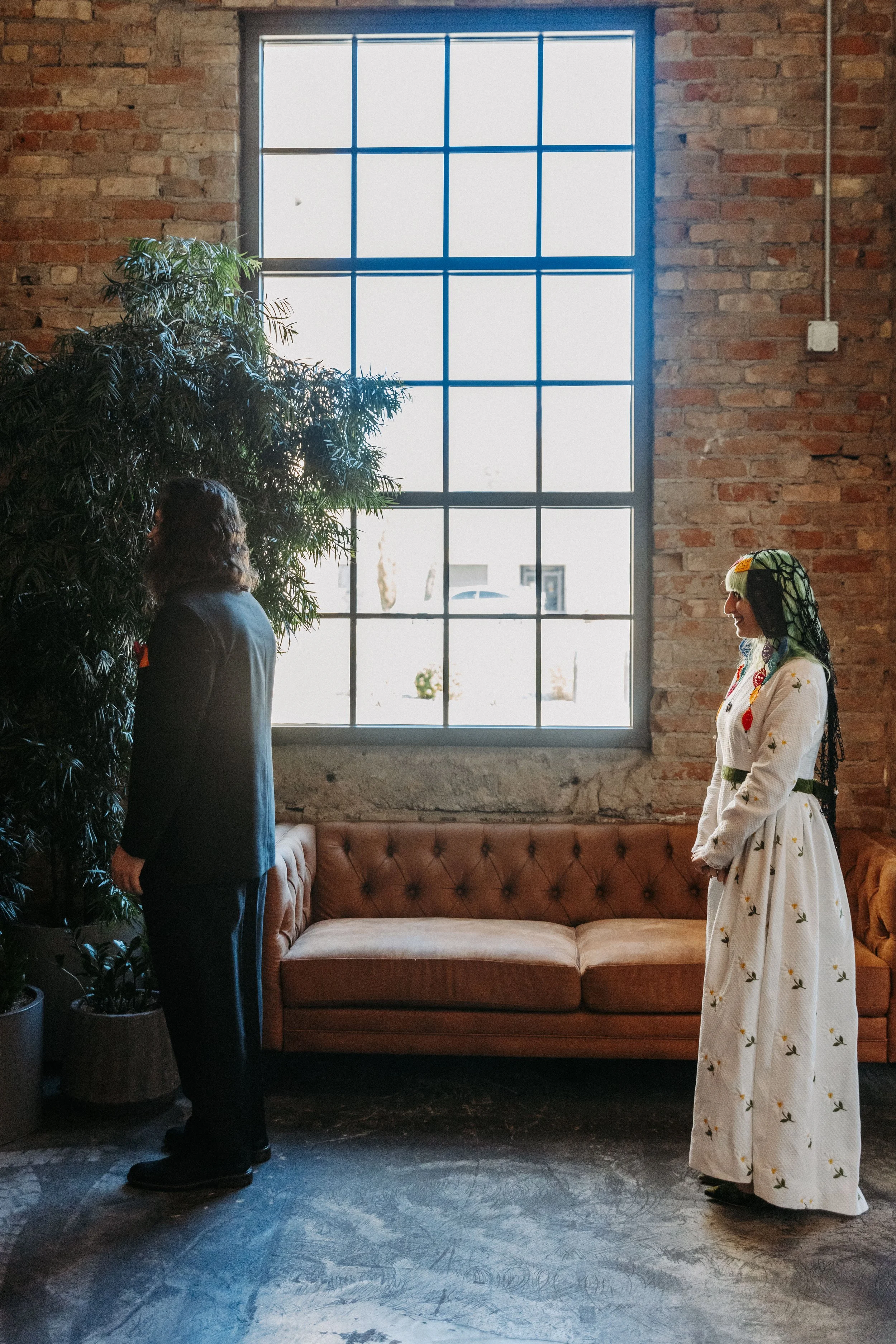 Bride approaches groom during a first look inside Crescent Hall, creating an intimate moment before their alternative wedding ceremony.
