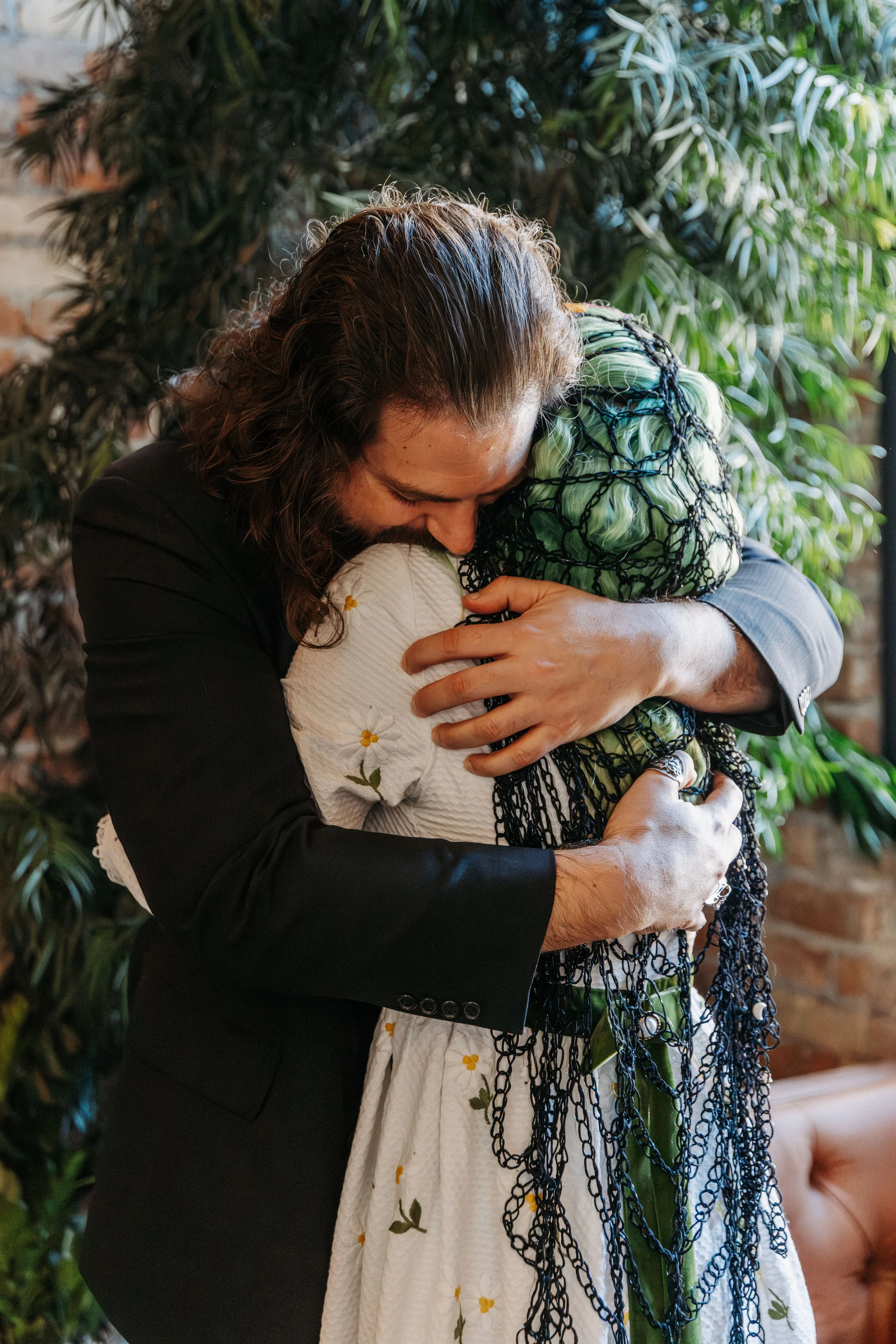 Bride and groom embrace during an emotional first look before their Día de los Muertos-inspired wedding celebration.