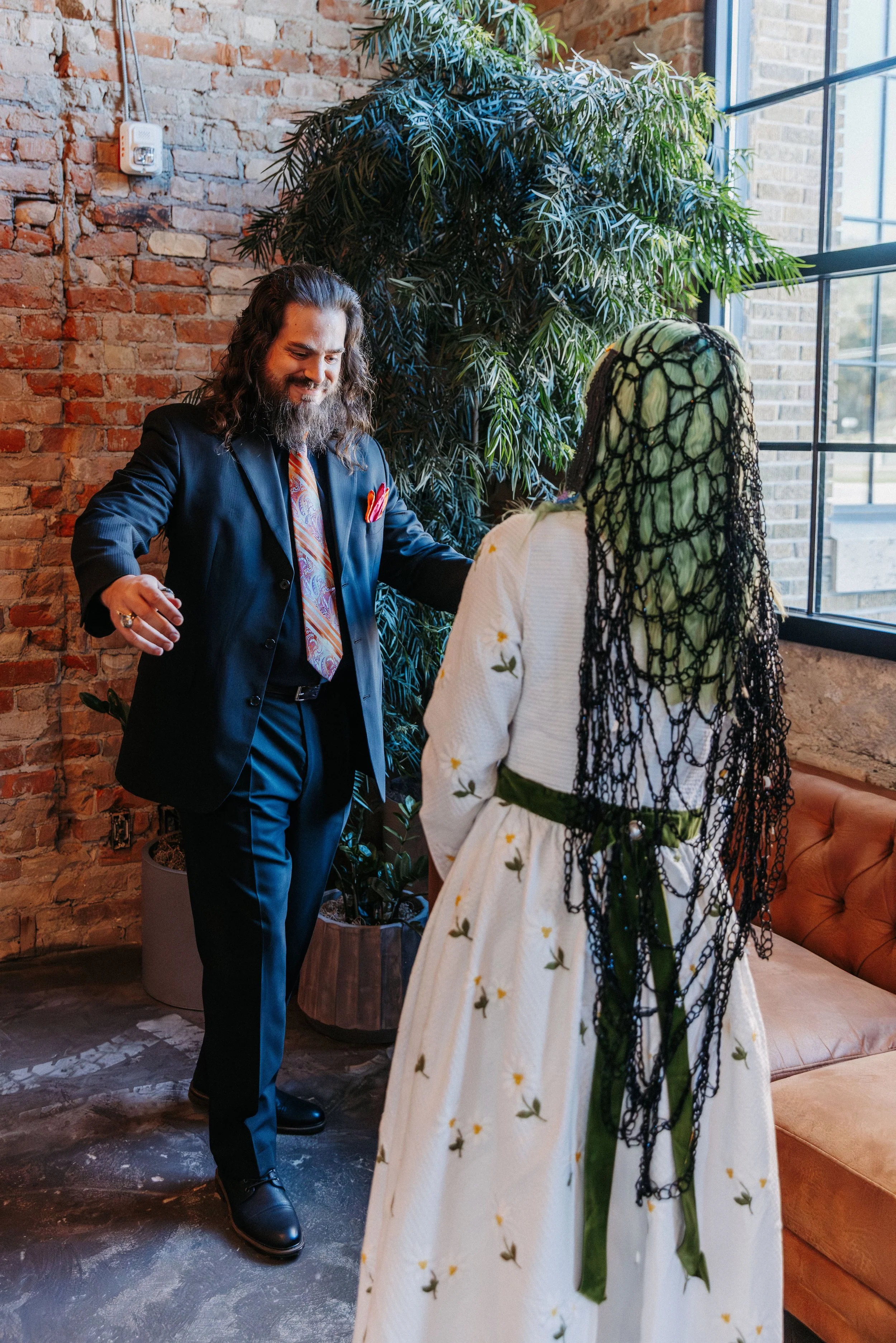 Bride and groom reach for one another during their first look, sharing an emotional reaction before their wedding ceremony.