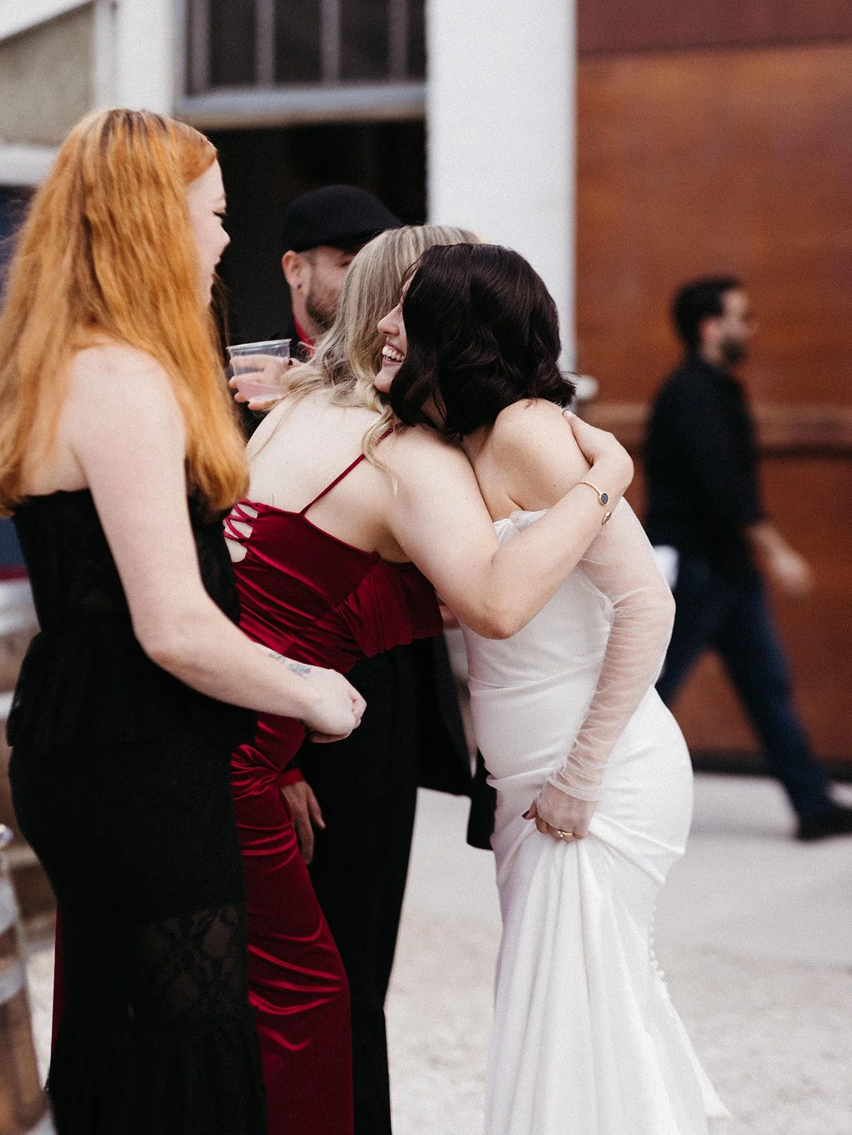 Bride greeting and hugging wedding guests during cocktail hour, creating meaningful moments and connection throughout a personalized wedding celebration.