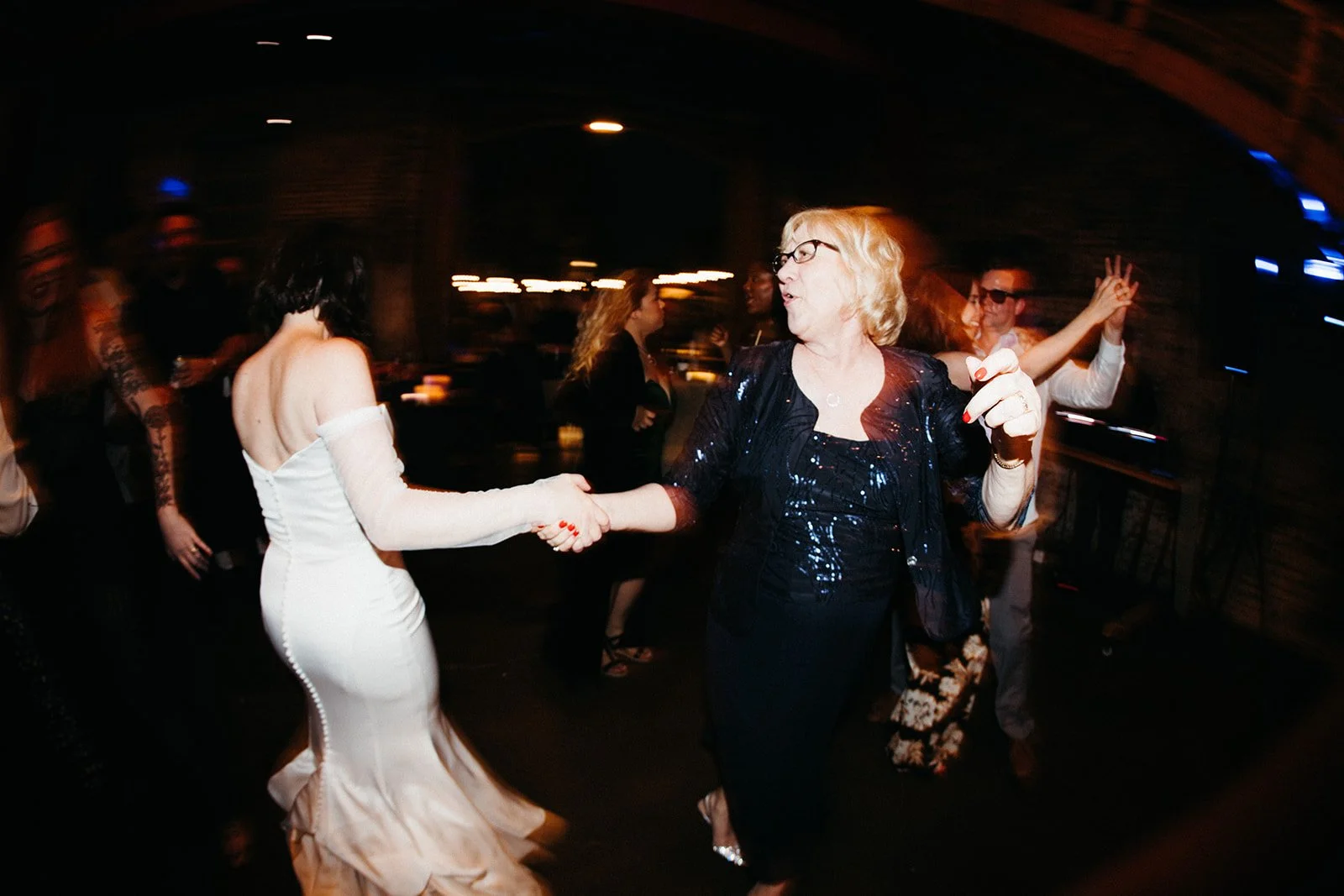 Wedding guests dancing and celebrating during an energetic reception, reflecting the seamless flow and guest experience created through professional wedding day coordination.