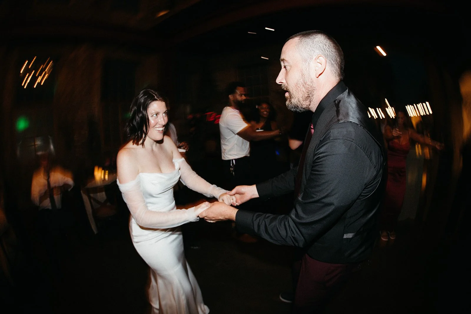 Newly married couple dancing together during a lively reception at an alternative wedding, highlighting the guest experience and atmosphere supported by thoughtful wedding day management.