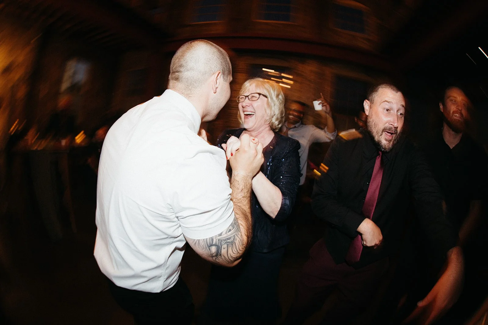 Family members and guests dancing together at a fun, unconventional wedding reception, showcasing the joyful moments couples can enjoy when event management handles the logistics behind the scenes.