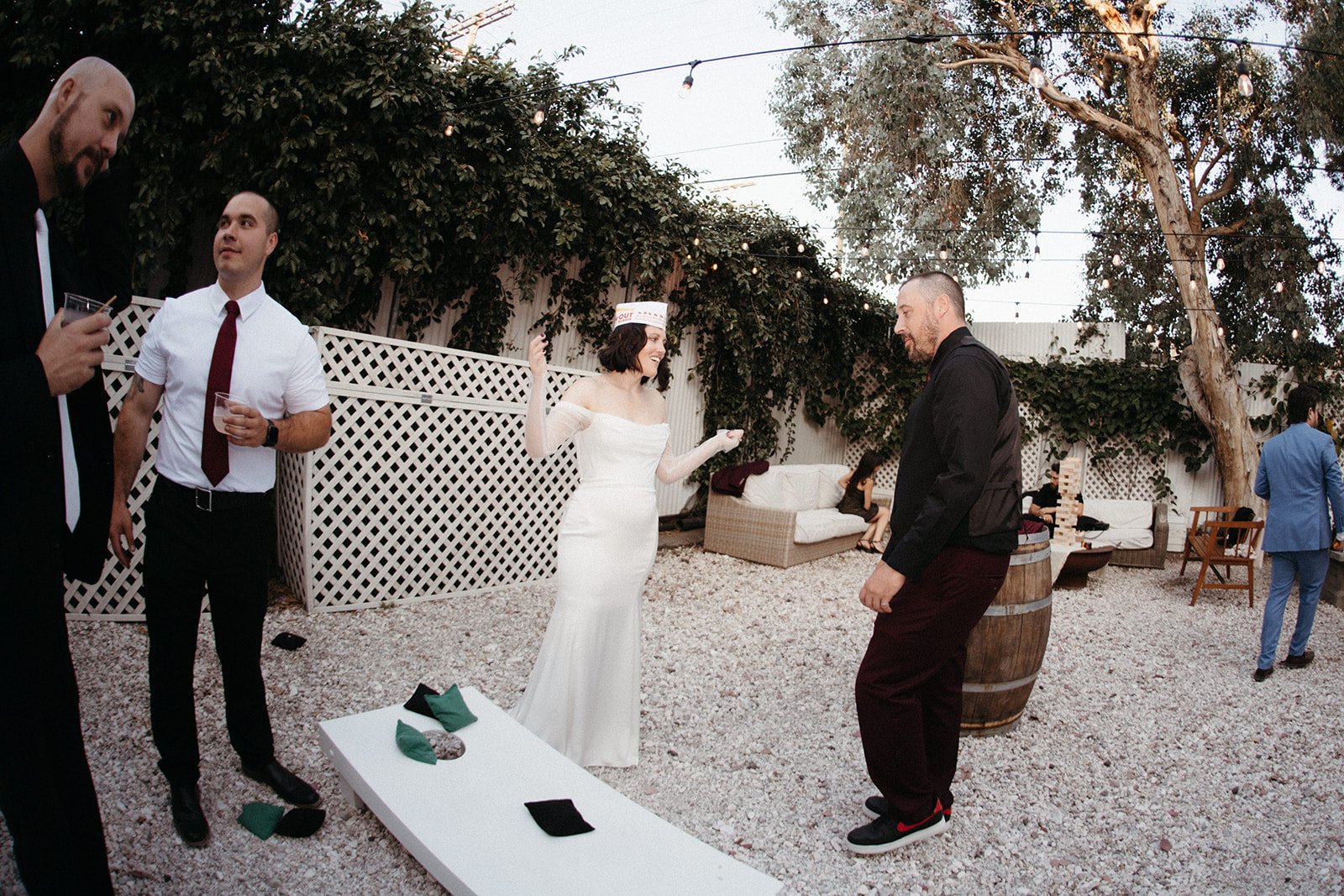 Bride and guests enjoying lawn games during outdoor cocktail hour at an alternative wedding, featuring interactive entertainment and a relaxed guest experience.