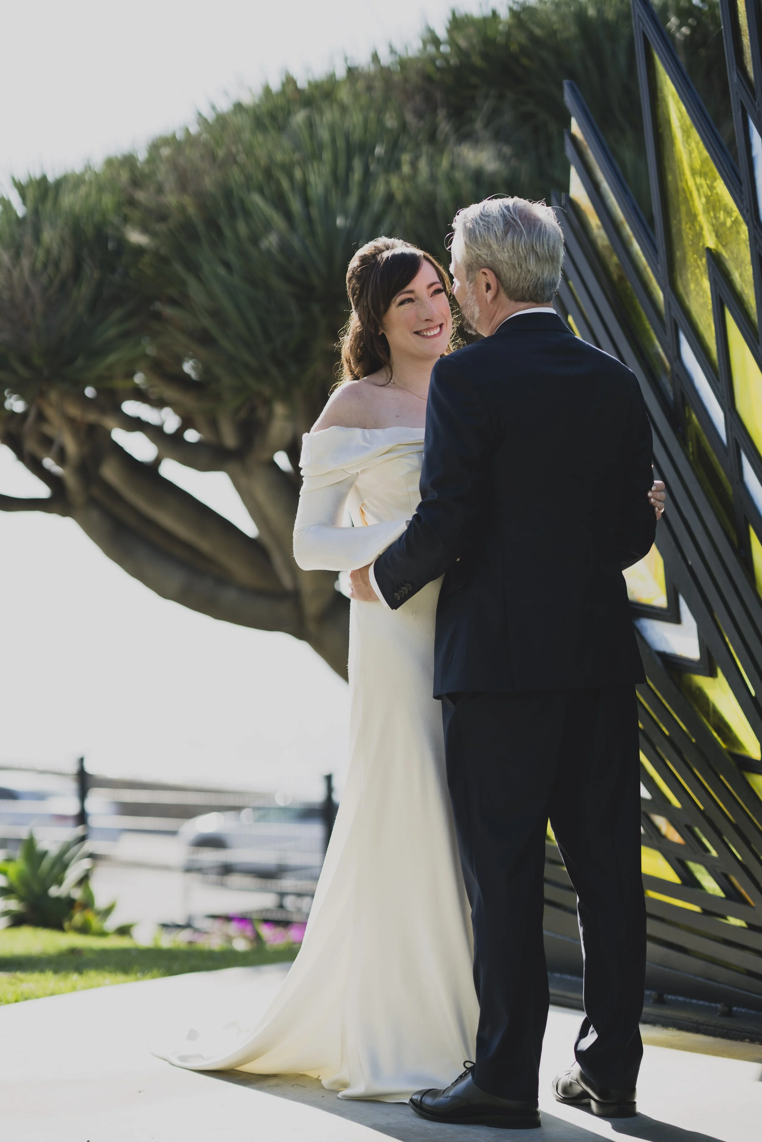 Bride and groom sharing a private portrait outside a modern wedding venue during their luxury destination wedding.