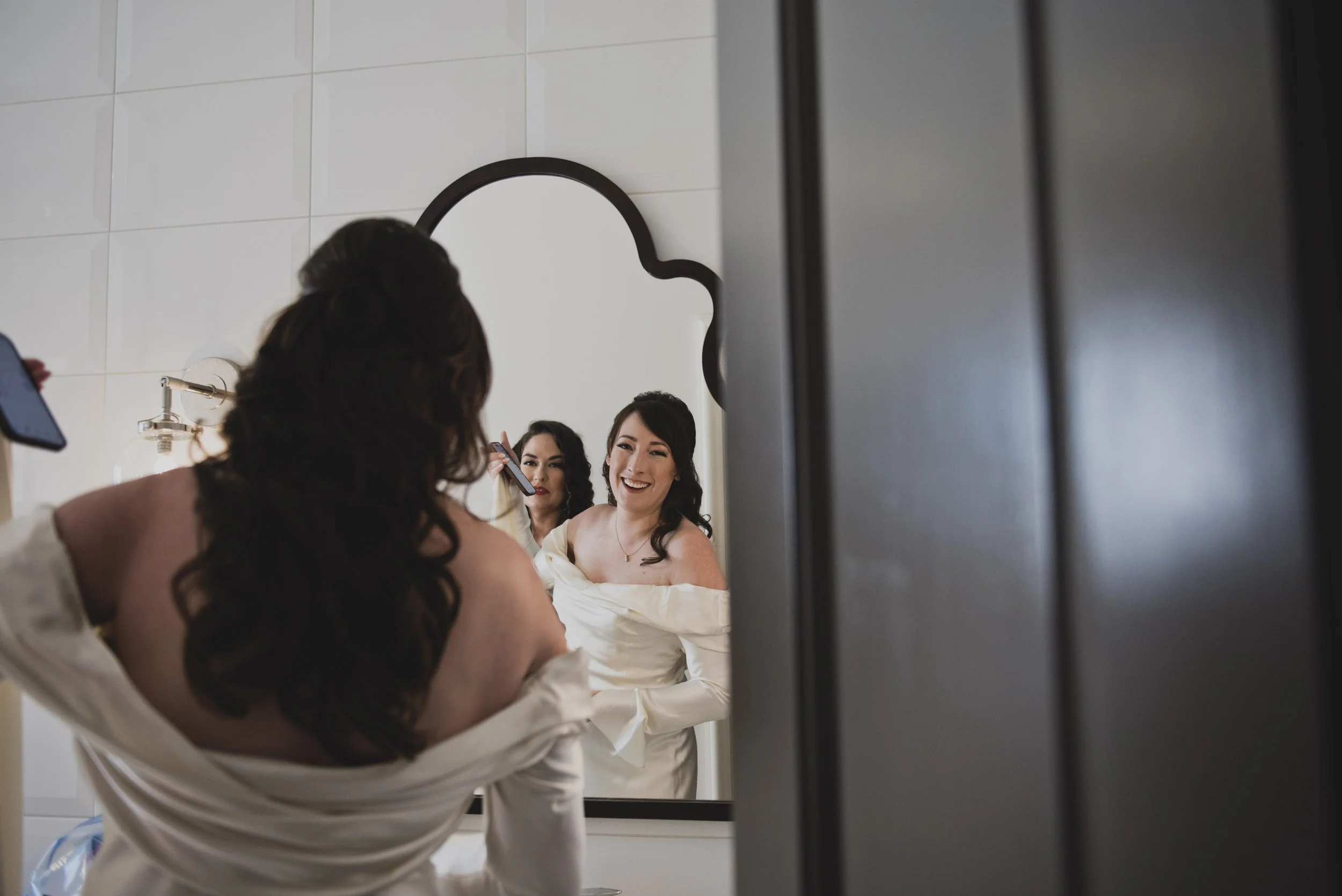 Bride getting ready with her bridal party while getting ready before a luxury destination wedding ceremony.
