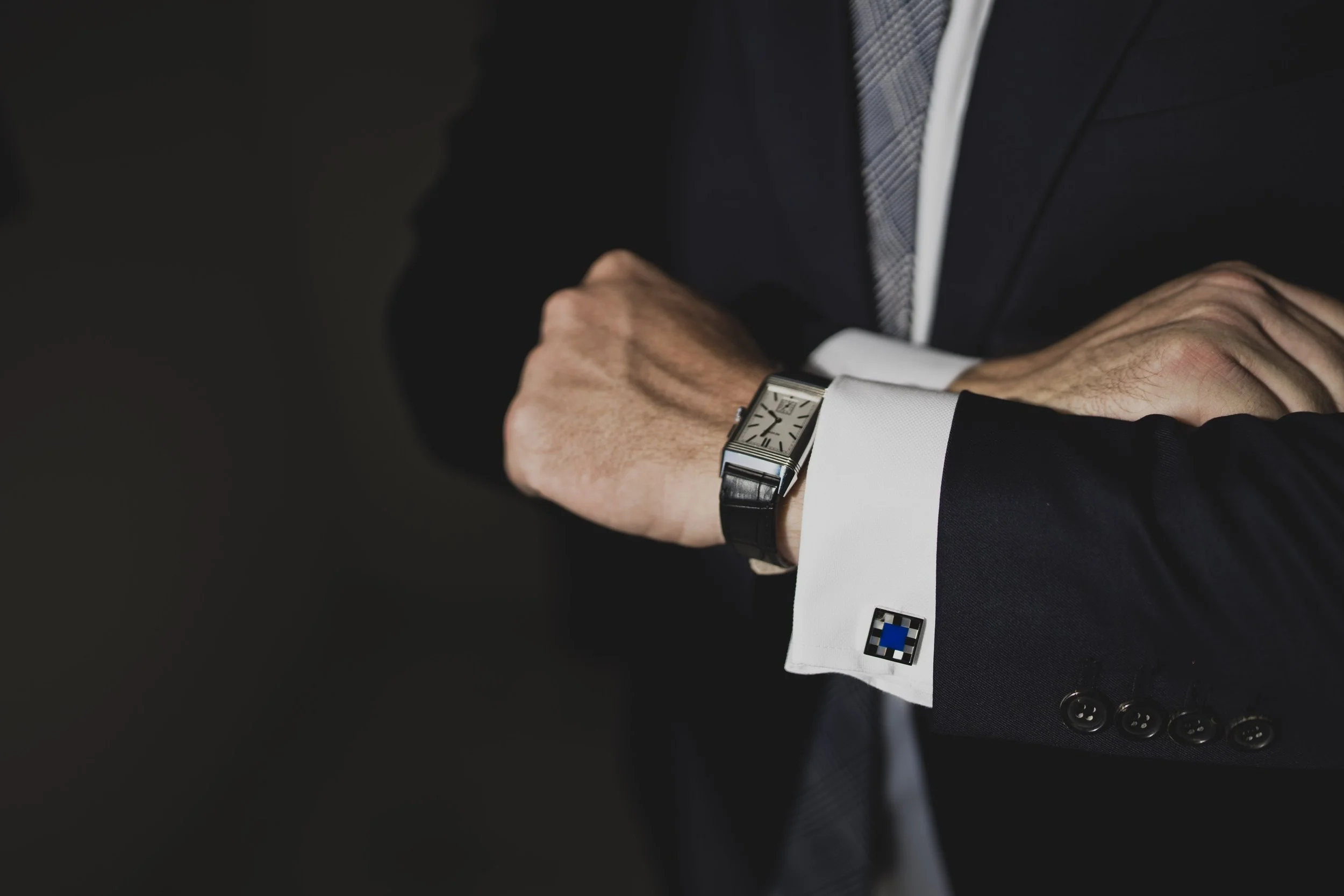 Close-up of the groom's watch and cufflinks while getting ready for a luxury destination wedding.