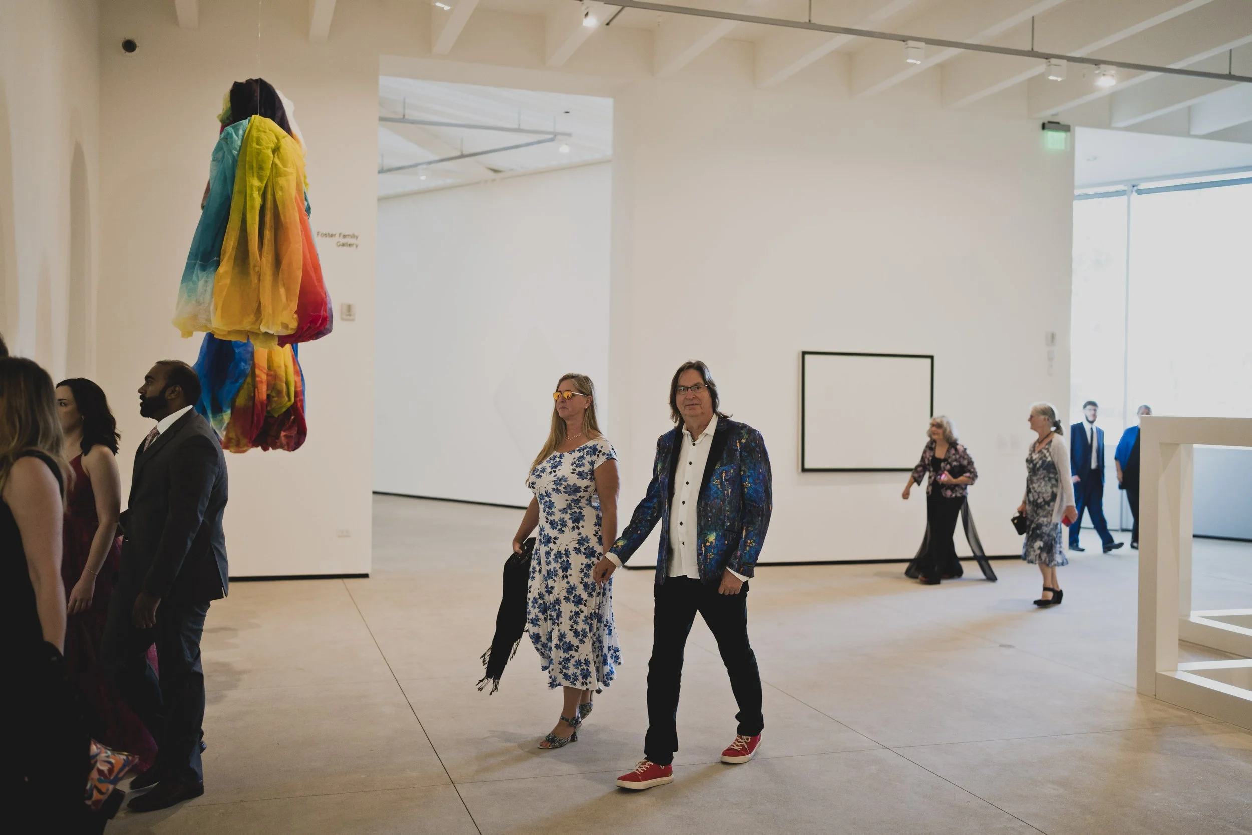 Wedding guests arriving inside a modern art museum before an oceanfront wedding ceremony.
