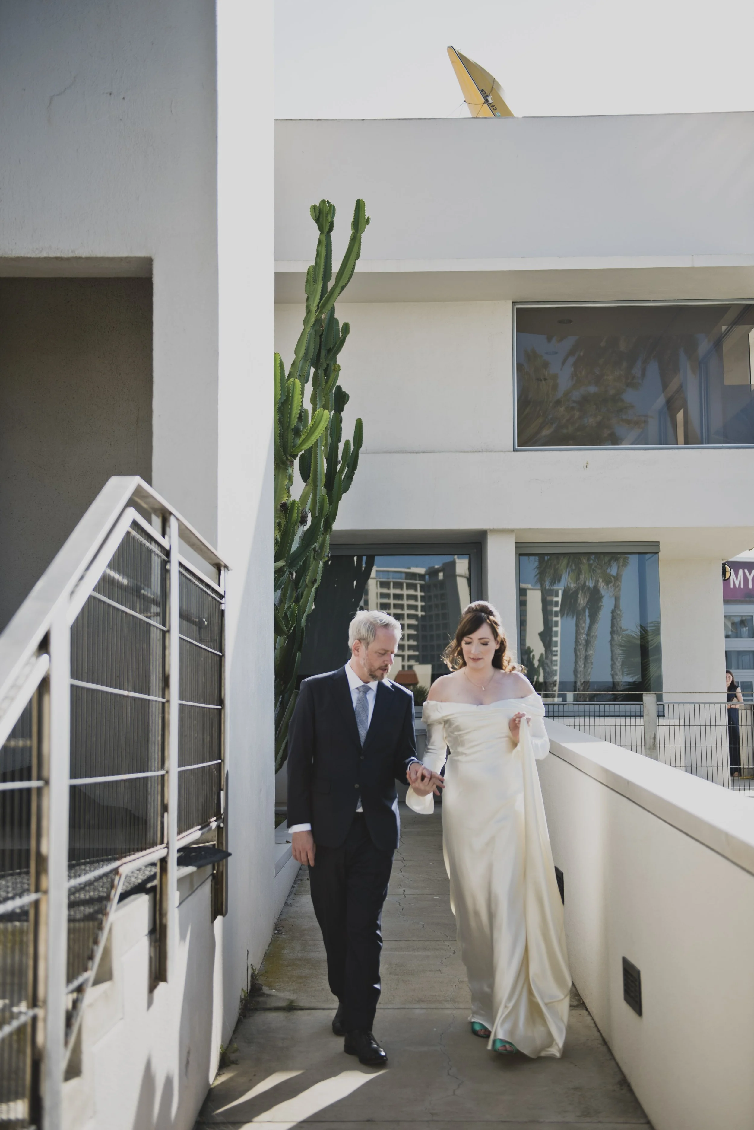 Bride and groom walking together outdoors before their destination wedding ceremony, enjoying a quiet moment together.