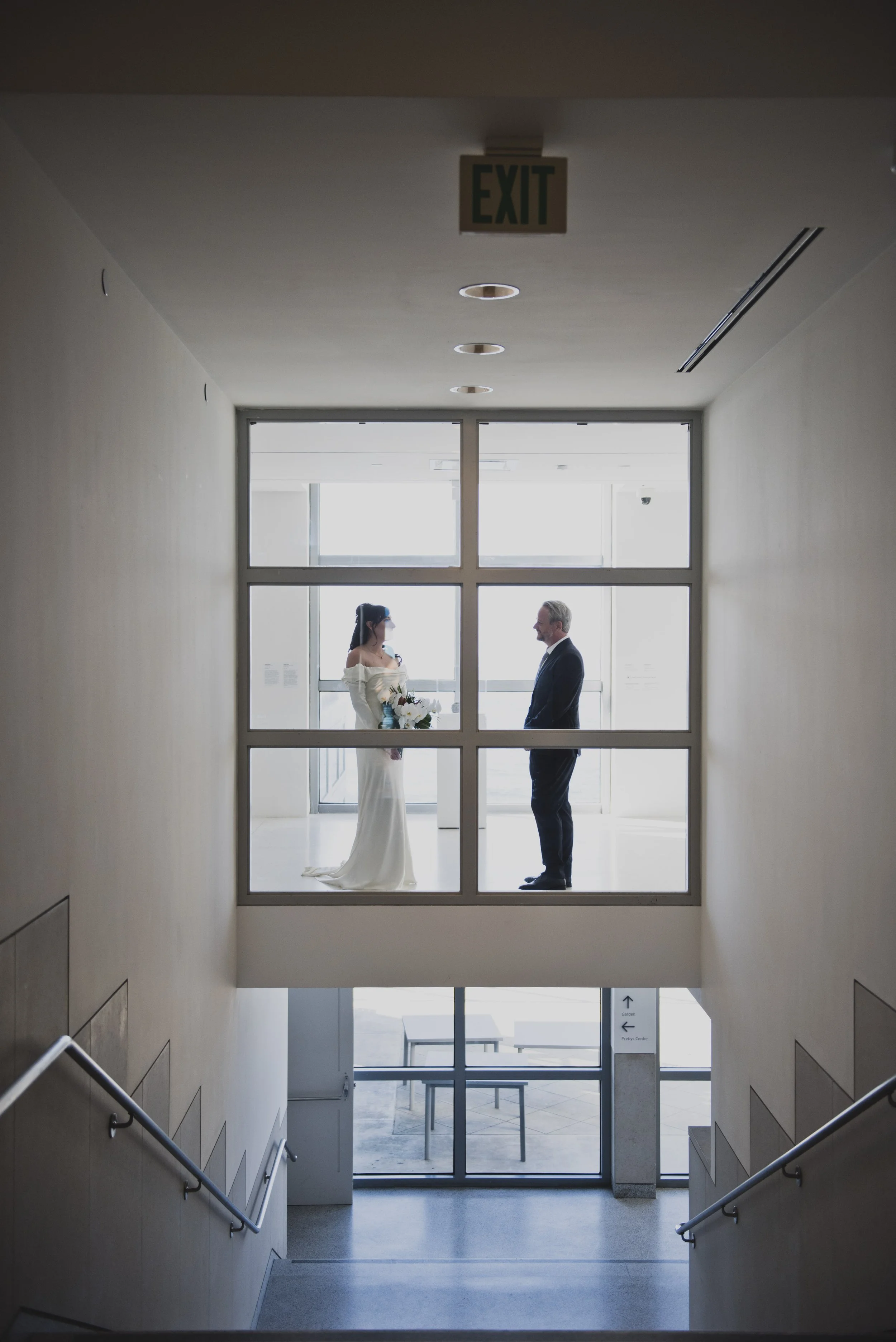 Bride and groom seeing each other during a private first look inside a modern destination wedding venue.