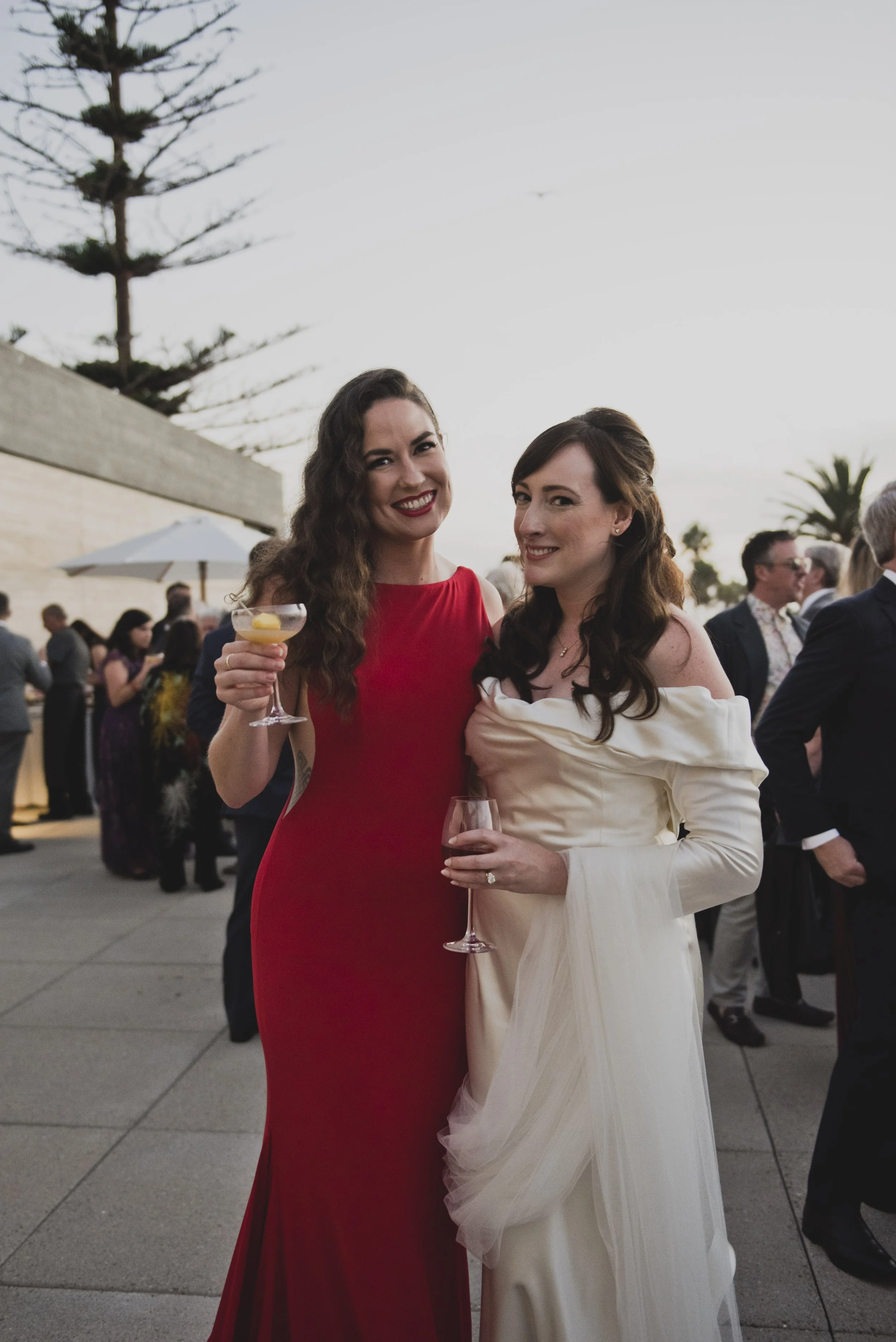 Bride enjoying cocktail hour with a guest during an intimate luxury destination wedding celebration.