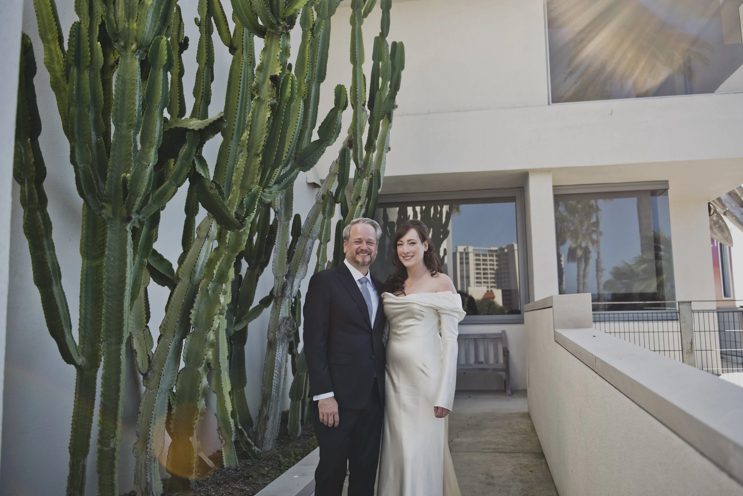 Bride and groom sharing a quiet first look beneath towering cacti before their destination wedding celebration.