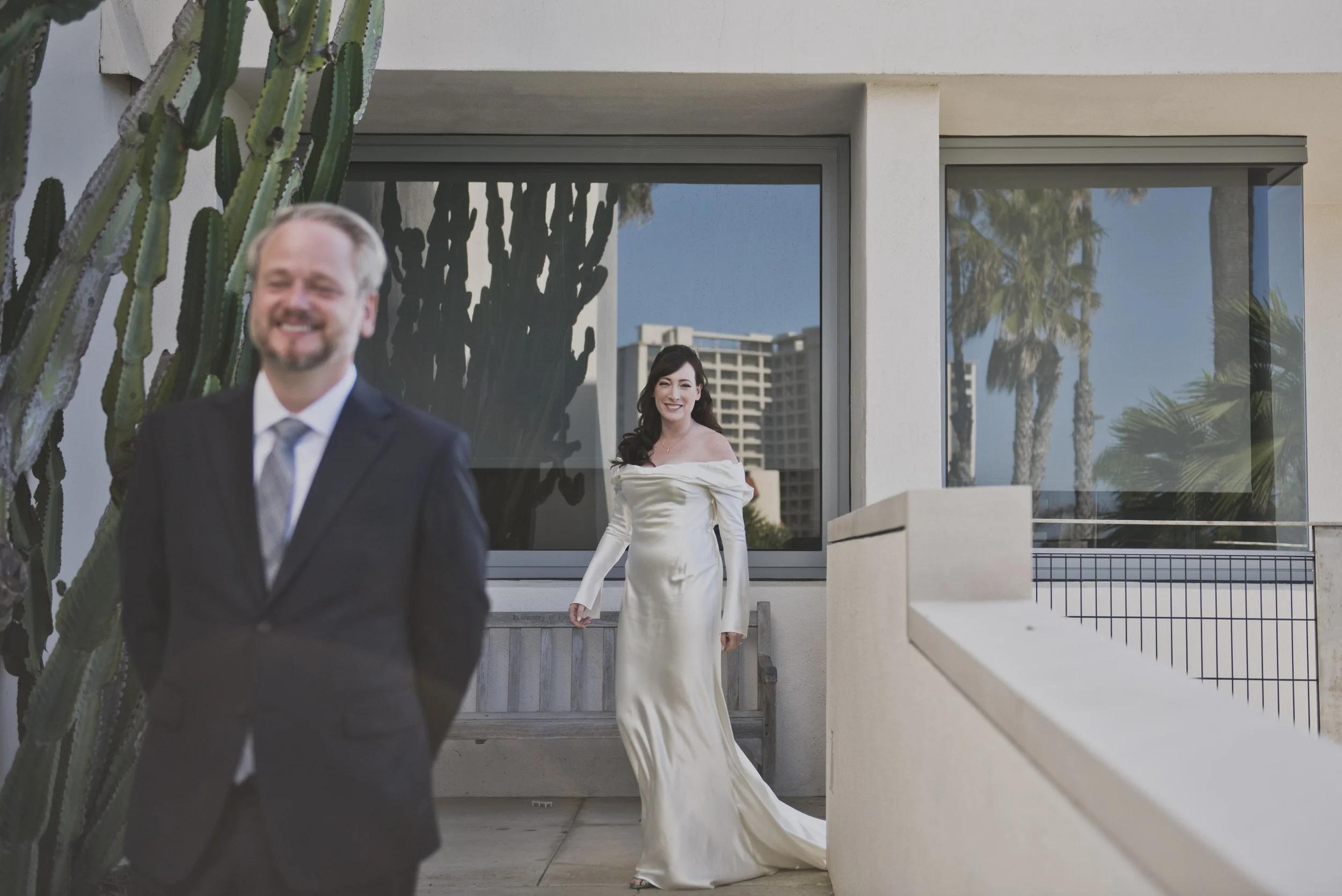 Bride and groom sharing a relaxed moment together before their destination wedding ceremony at a modern venue.