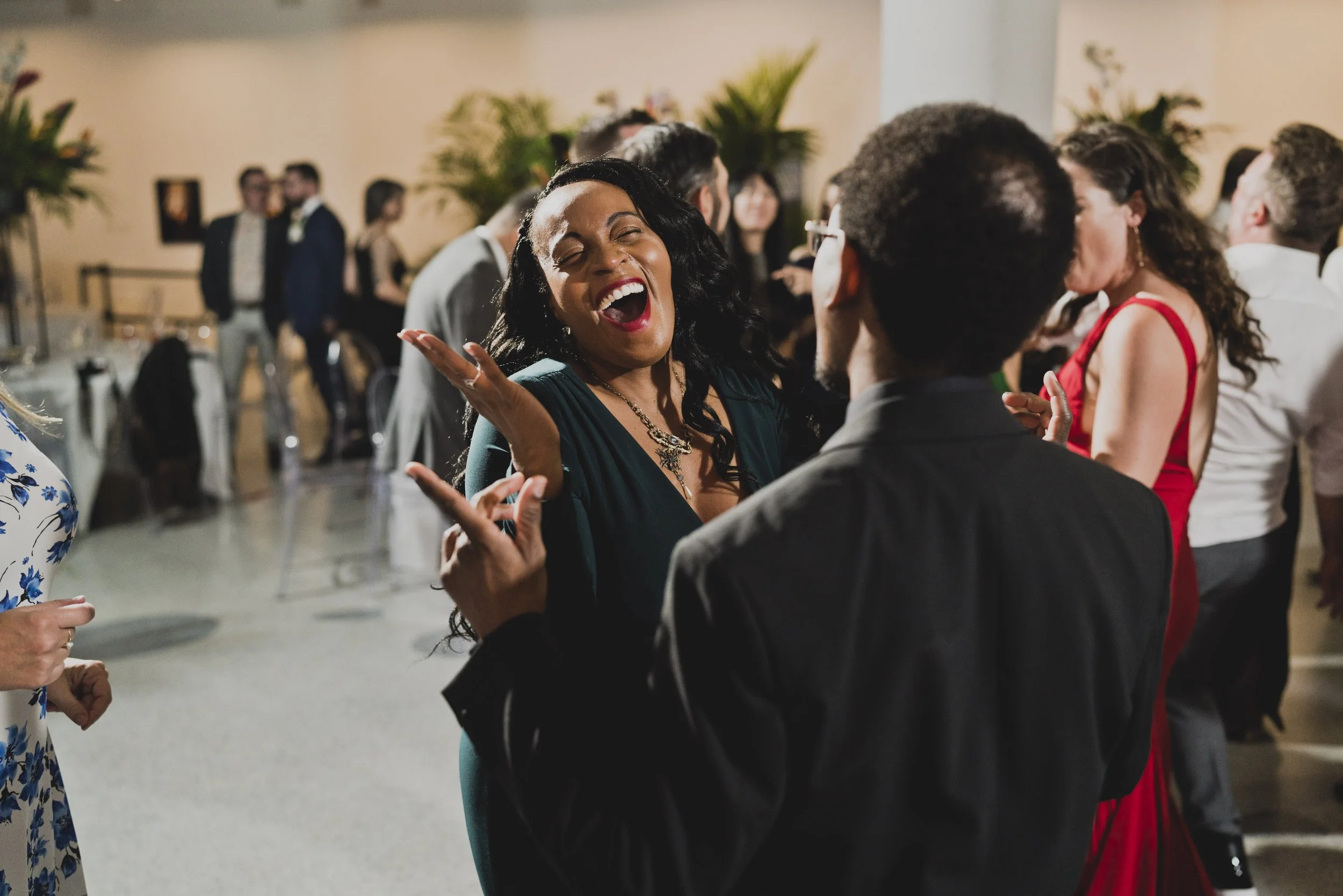 Guests laughing and enjoying the reception at a luxury destination wedding, capturing the kind of celebration thoughtful planning creates.