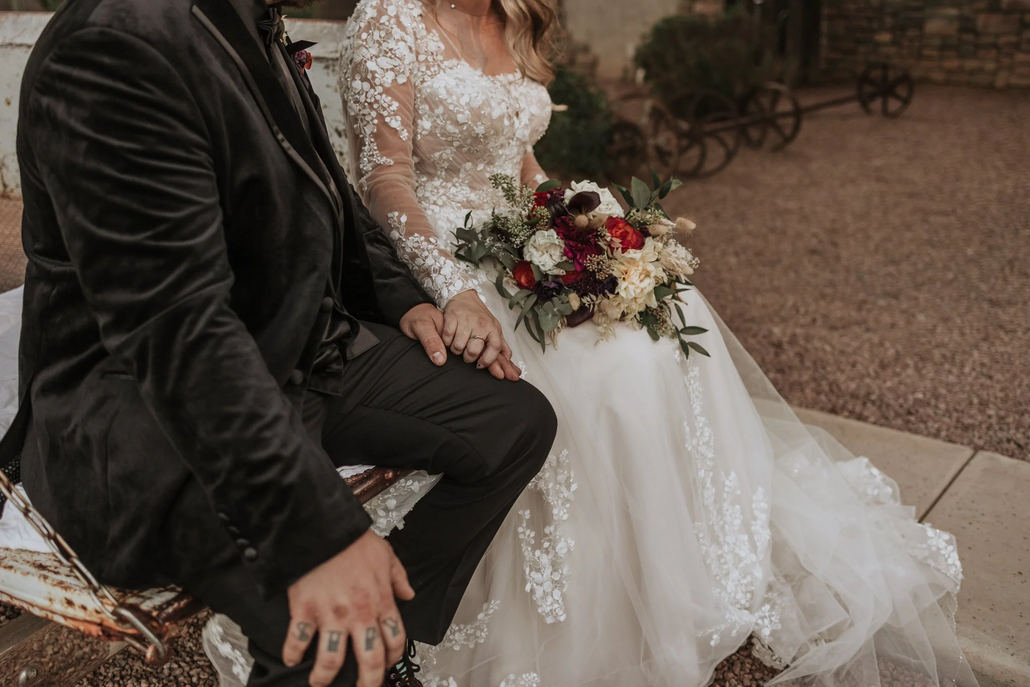 Close-up of the bride and groom black wedding bands during their outdoor wedding ceremony with vintage truck.