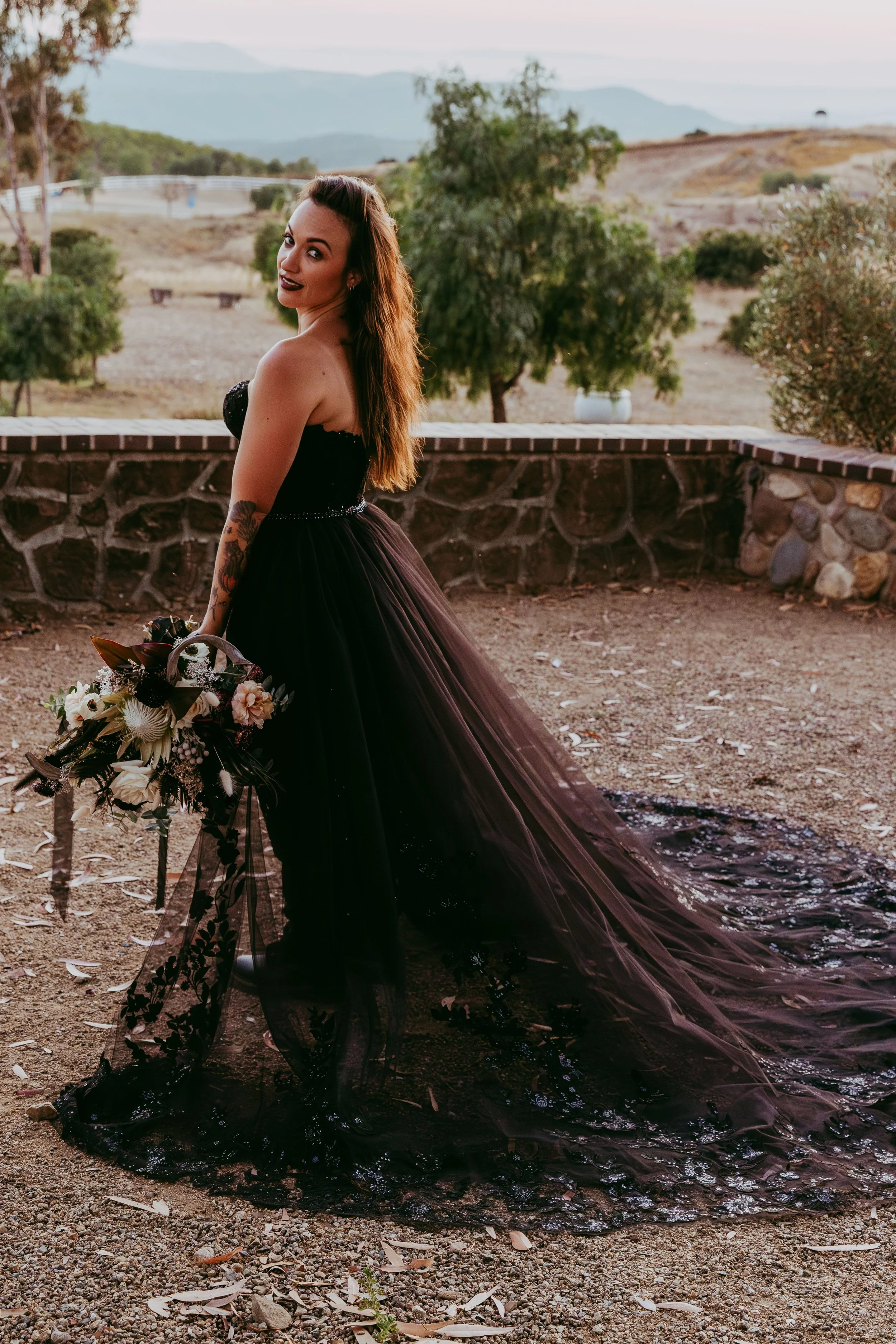 Details of a dark wedding dress on an alternative bride