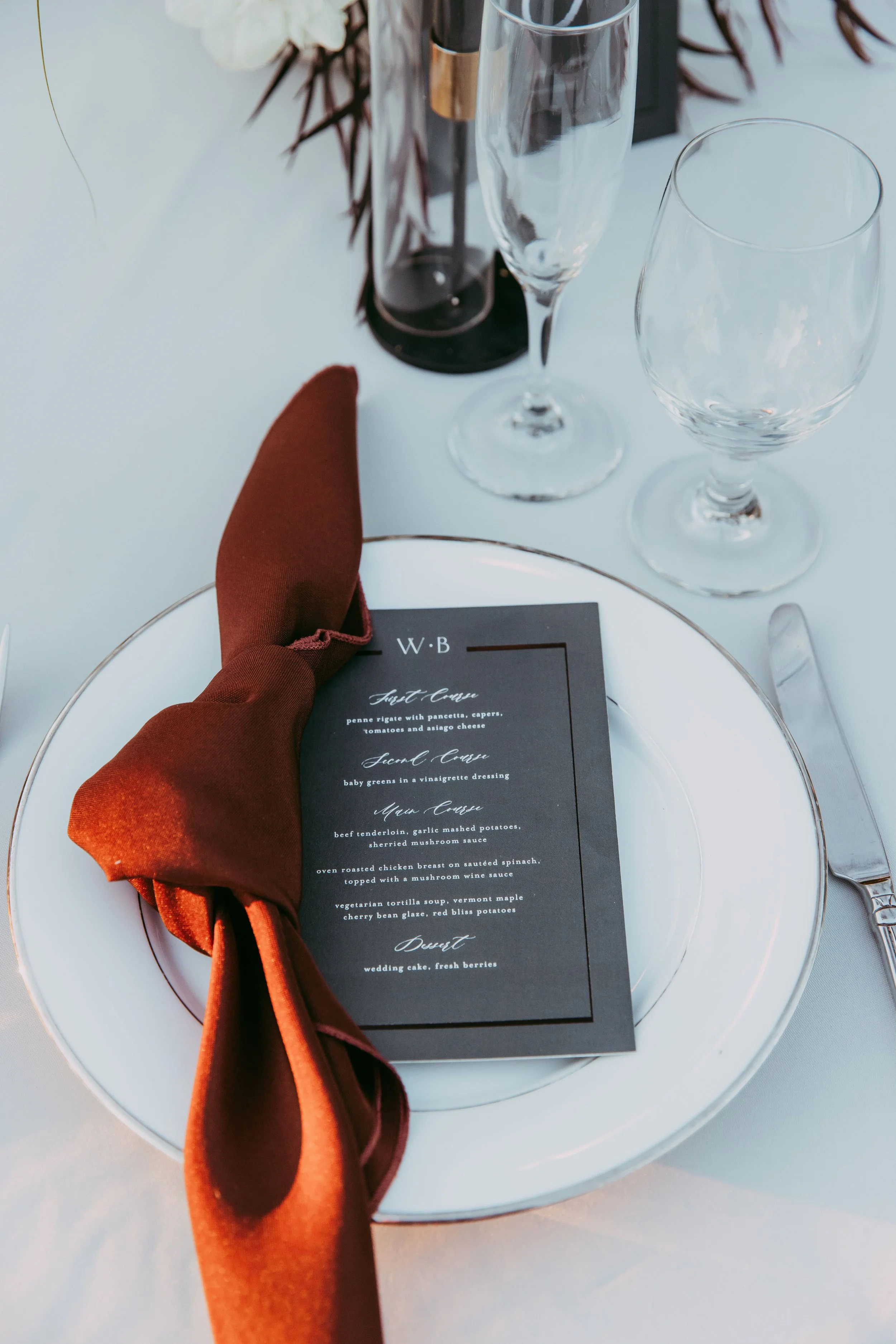 Place setting with stone-textured linens and napkins at a Scar villain wedding